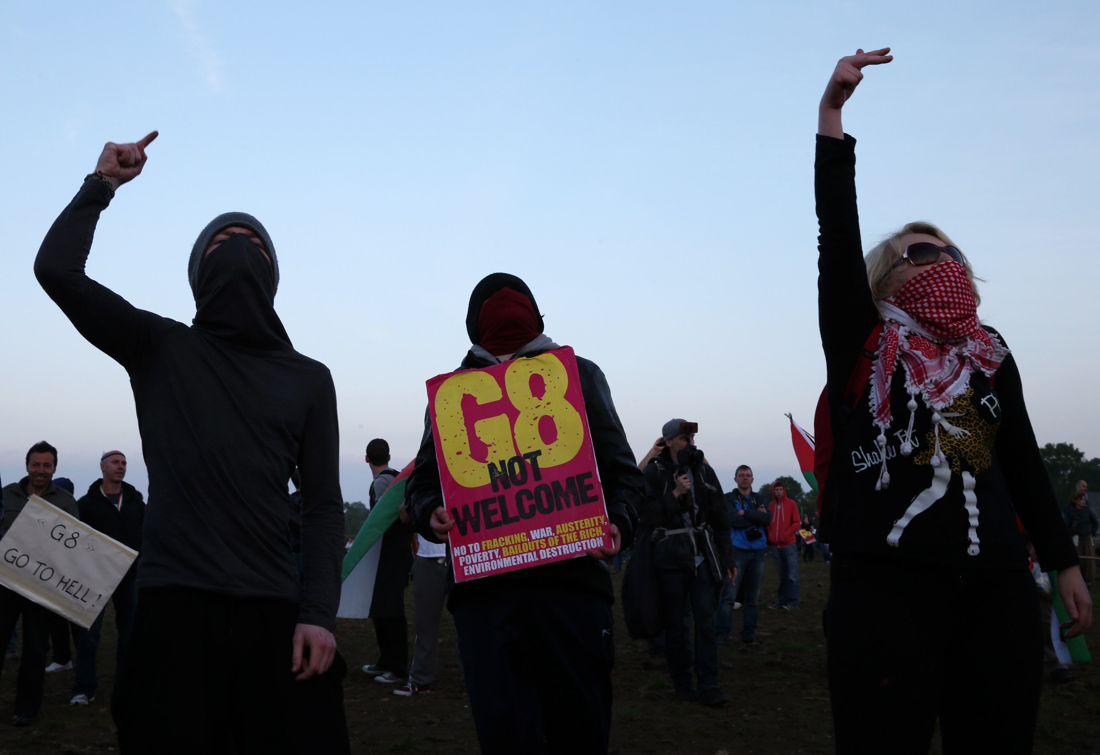 Anti-G8 protester gesture towards police at the G8 summit venue at Lough Erne on June 17, 2013 in Enniskillen, Northern Ireland. The two day G8 summit, hosted by UK Prime Minister David Cameron, is being held in Northern Ireland for the first time. Leaders from the G8 nations have gathered to discuss numerous topics with the situation in Syria expected to dominate the talks. (Photo by Peter Macdiarmid/Getty Images)