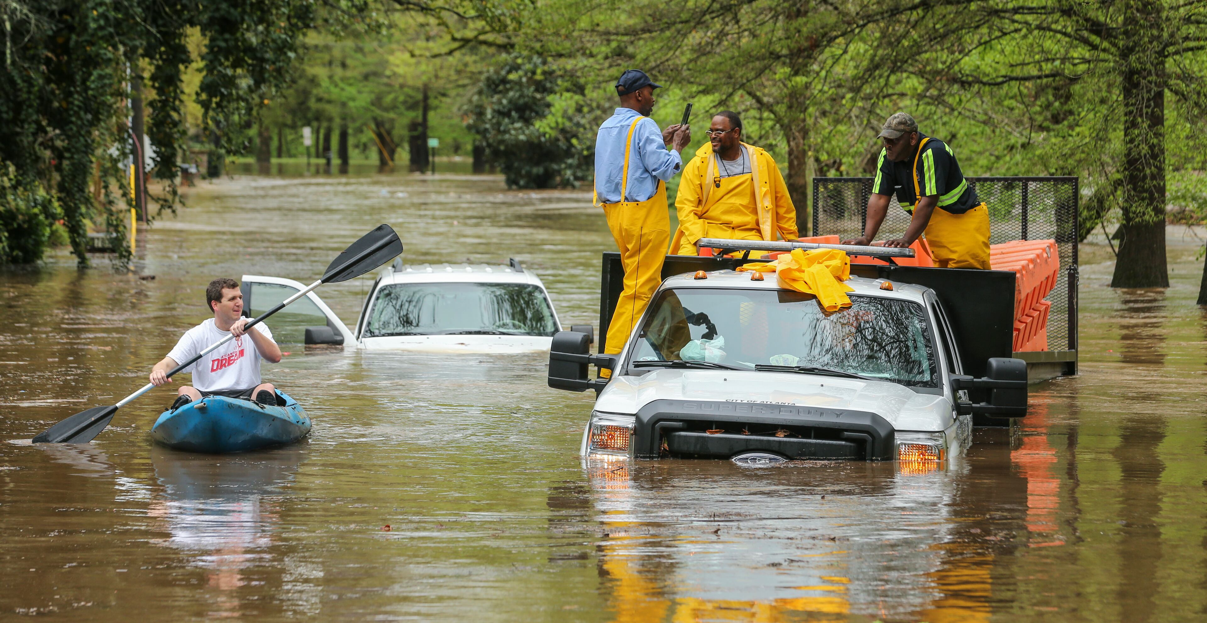 An Atlanta Public Works crew got caught in the Peachtree Creek overflow onto the flooded Woodward Way as they were delivering Road Block equipment and had to be rescued by the Atlanta Fire Rescue's Swift Water Dive Team. Water Multiple rounds of dangerous weather visited metro Atlanta on Wednesday, April 5, 2017.