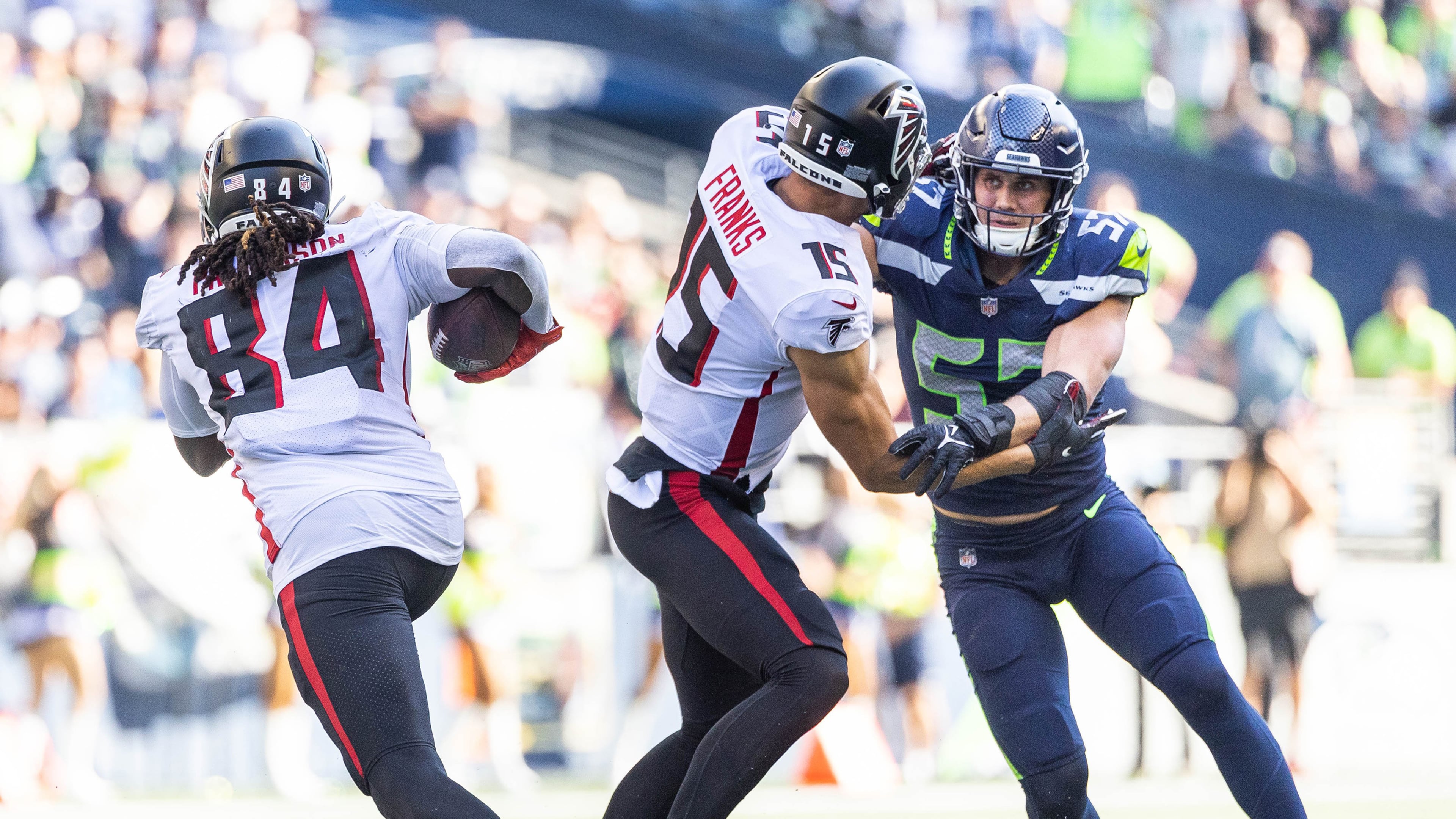Seattle's Cody Barton is taken out of the play by Atlanta's Feleipe Franks, giving Cordarrelle Patterson room to run for 18 yards in the third quarter Sunday at Lumen Field in Seattle. (Dean Rutz/The Seattle Times/TNS)
