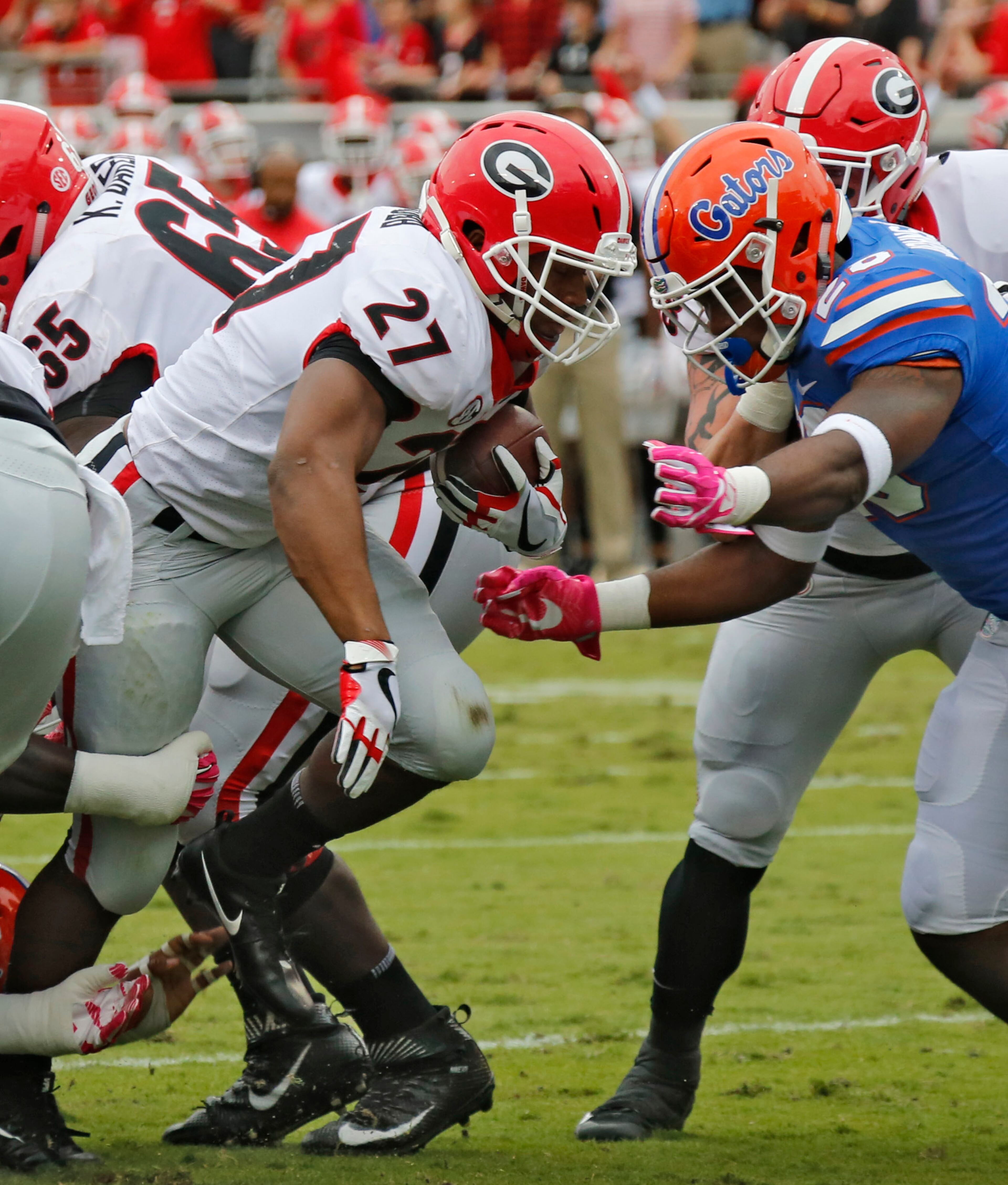 10/28/17 - Jacksonville, FL - Georgia Bulldogs running back Nick Chubb (27) breaks through the line to score Georgia's first TD. NCAA football game between Georgia and Florida at EverBank Field in Jacksonville. BOB ANDRES /BANDRES@AJC.COM