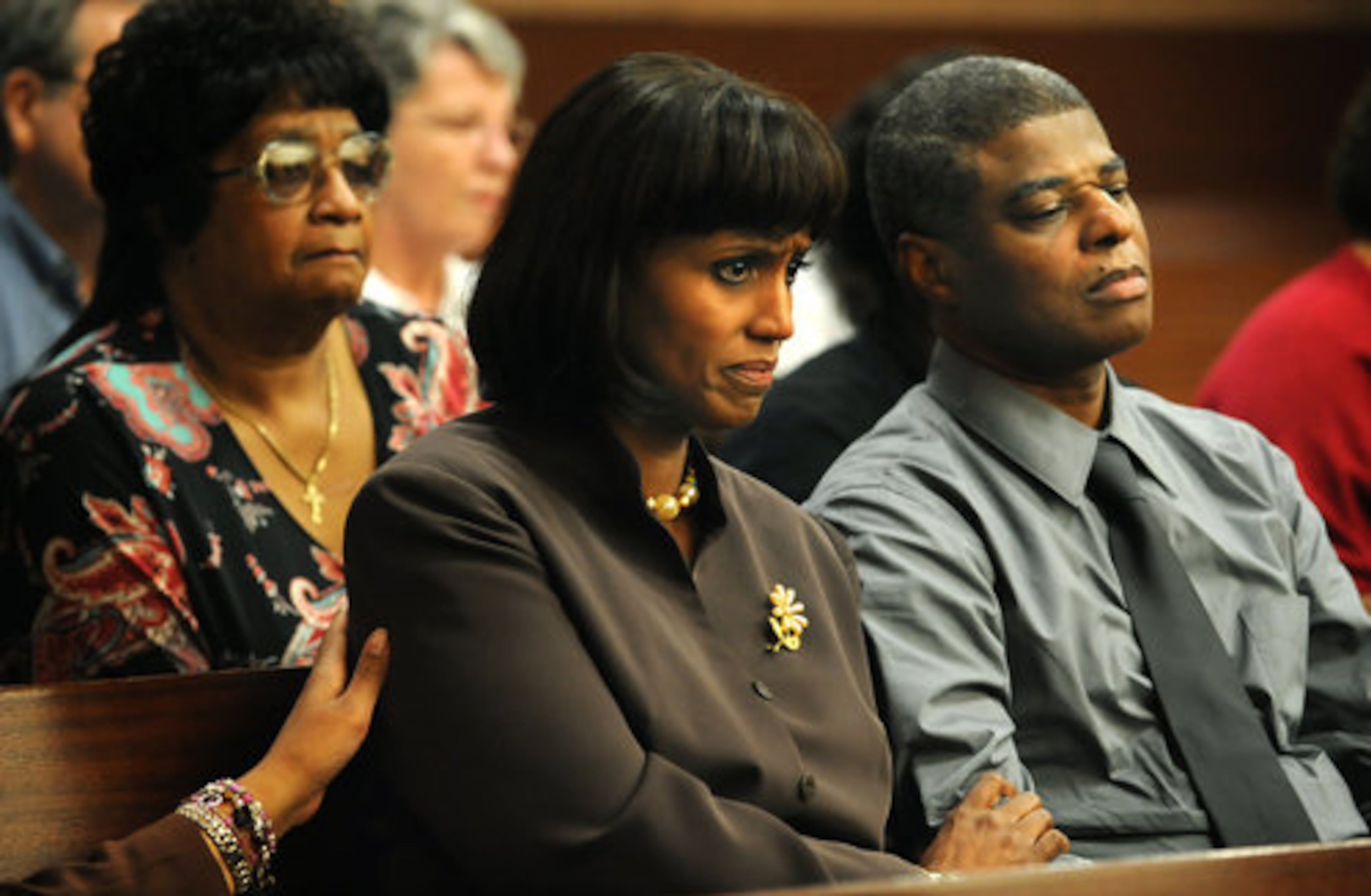 Family members of Sparkle Reid Rai, who was murdered eight years ago, listen to evidence presented in Fulton Superior Court during the trial last week. At right is her father, Bennet Reid Jr. Holding his hand is Donna Lowry Reid, Sparkle Reid Rai's stepmother.