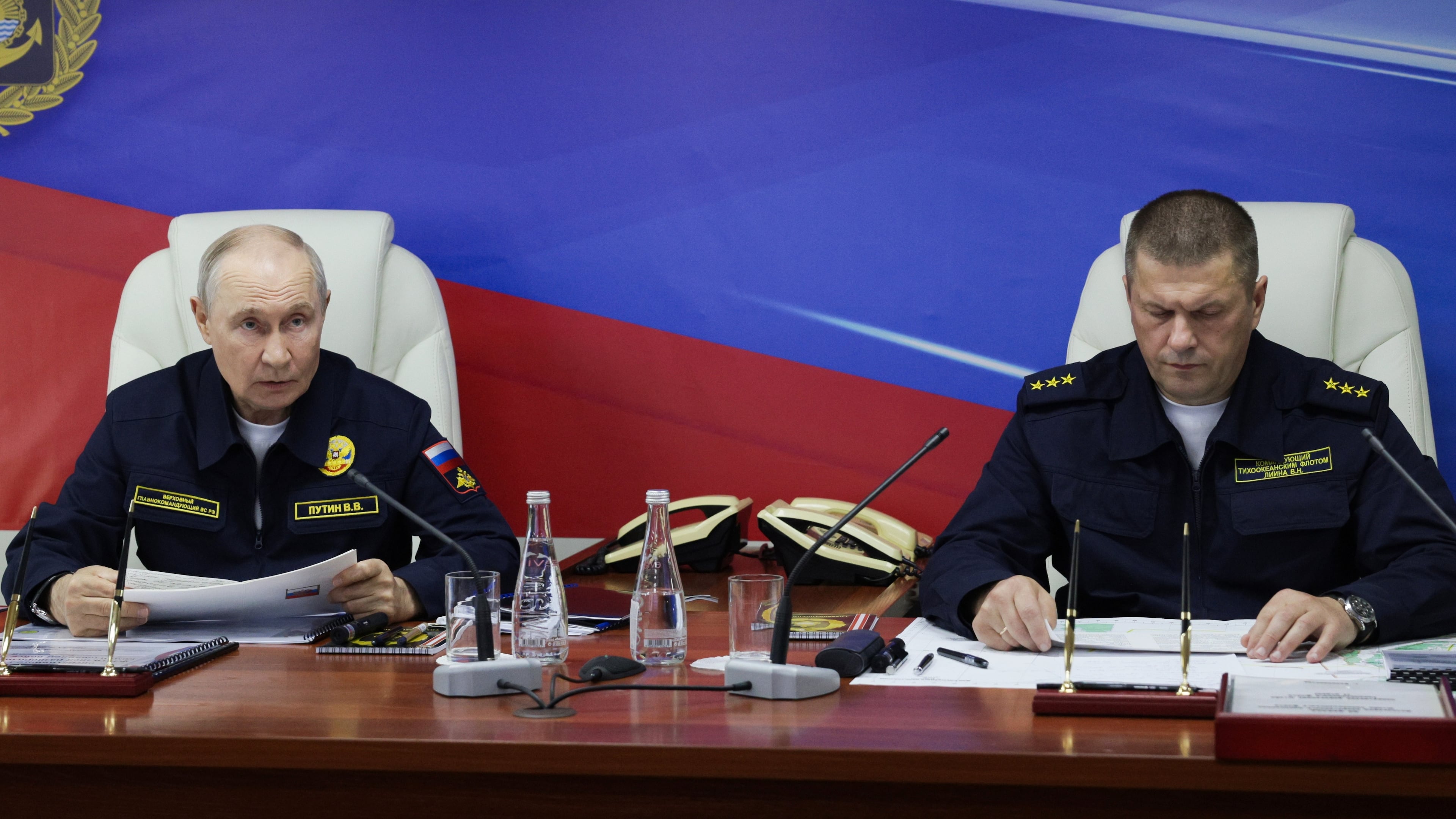Russian President Vladimir Putin, left, and Russian Pacific Fleet Commander-in-Chief Admiral Viktor Liina attends a meeting with navy officers on board of the Varyag missile cruiser of the Pacific Fleet during a military exercise near Yuzhno-Sakhalinsk, on Sakhalin Island, Russia, Wednesday, Aug. 12, 2026. (Gavriil Grigorov, Sputnik, Kremlin Pool Photo via AP)