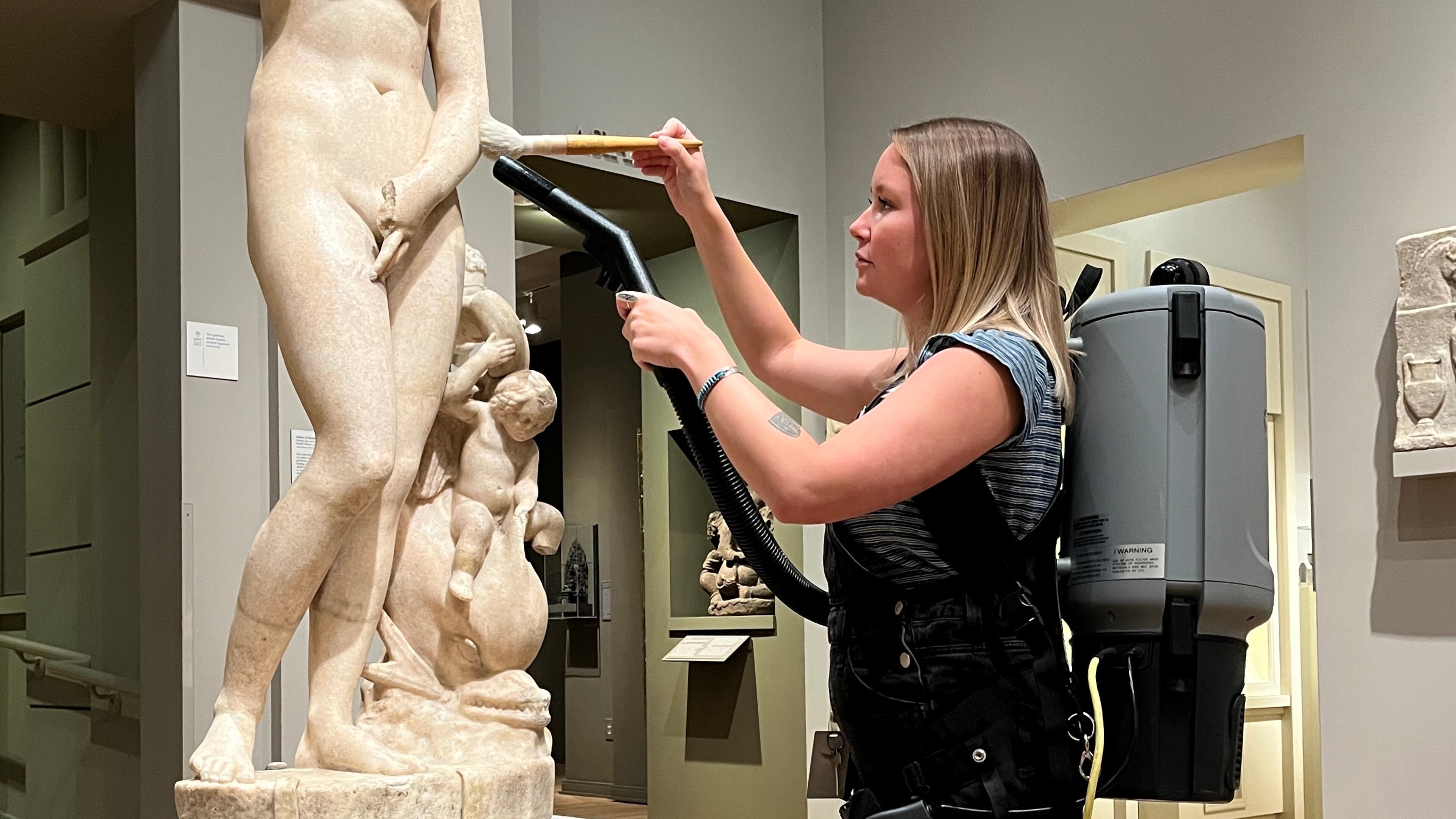 Objects conservator Ella Andrews vacuums a marble sculpture at the Michael C. Carlos Museum at Emory University. Photo: Courtesy of Carlos Museum