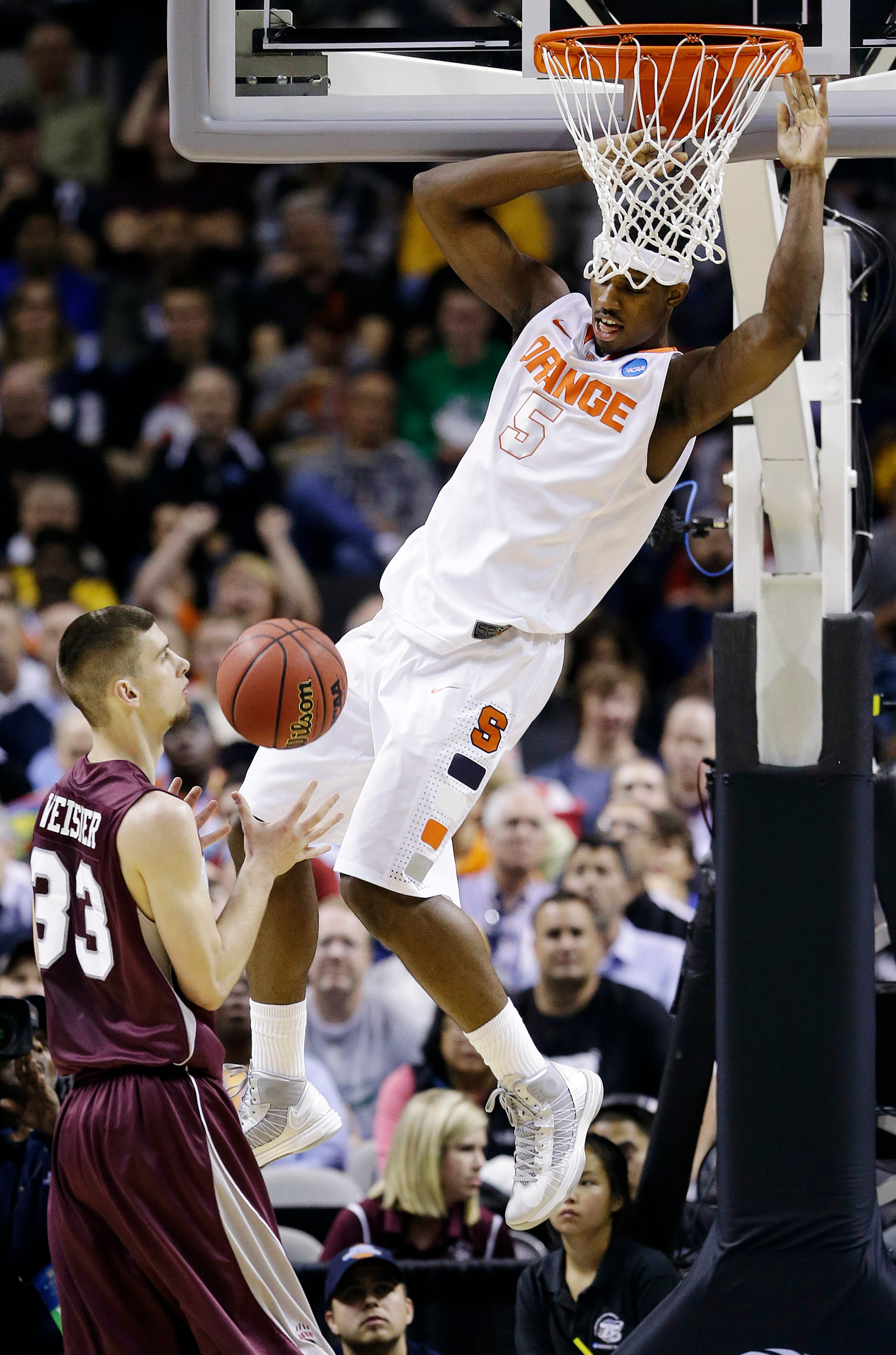Syracuse forward C.J. Fair (5) dunks over Montana forward Mike Weisner (33) during the first half of a second-round game in the NCAA college basketball tournament in San Jose, Calif., Thursday, March 21, 2013. (AP Photo/Jeff Chiu)