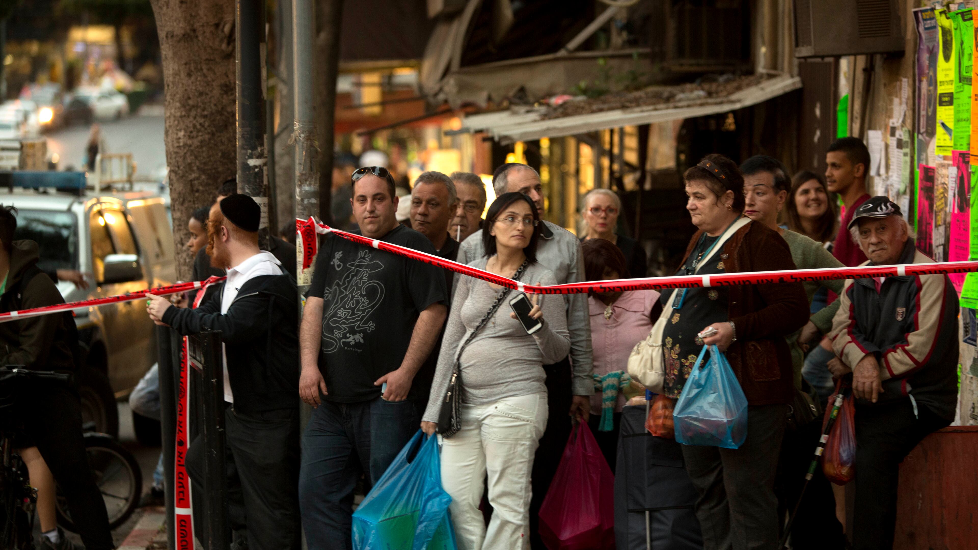 Israelis look at the scene of a stabbing attack in the central Israeli city of Petah Tikvah, in this March file photo. A Palestinian opened fire at Israeli police officers outside Jerusalem's Old City on Tuesday, seriously wounding two of them before being shot dead, police said. AP/Sebastian Scheiner