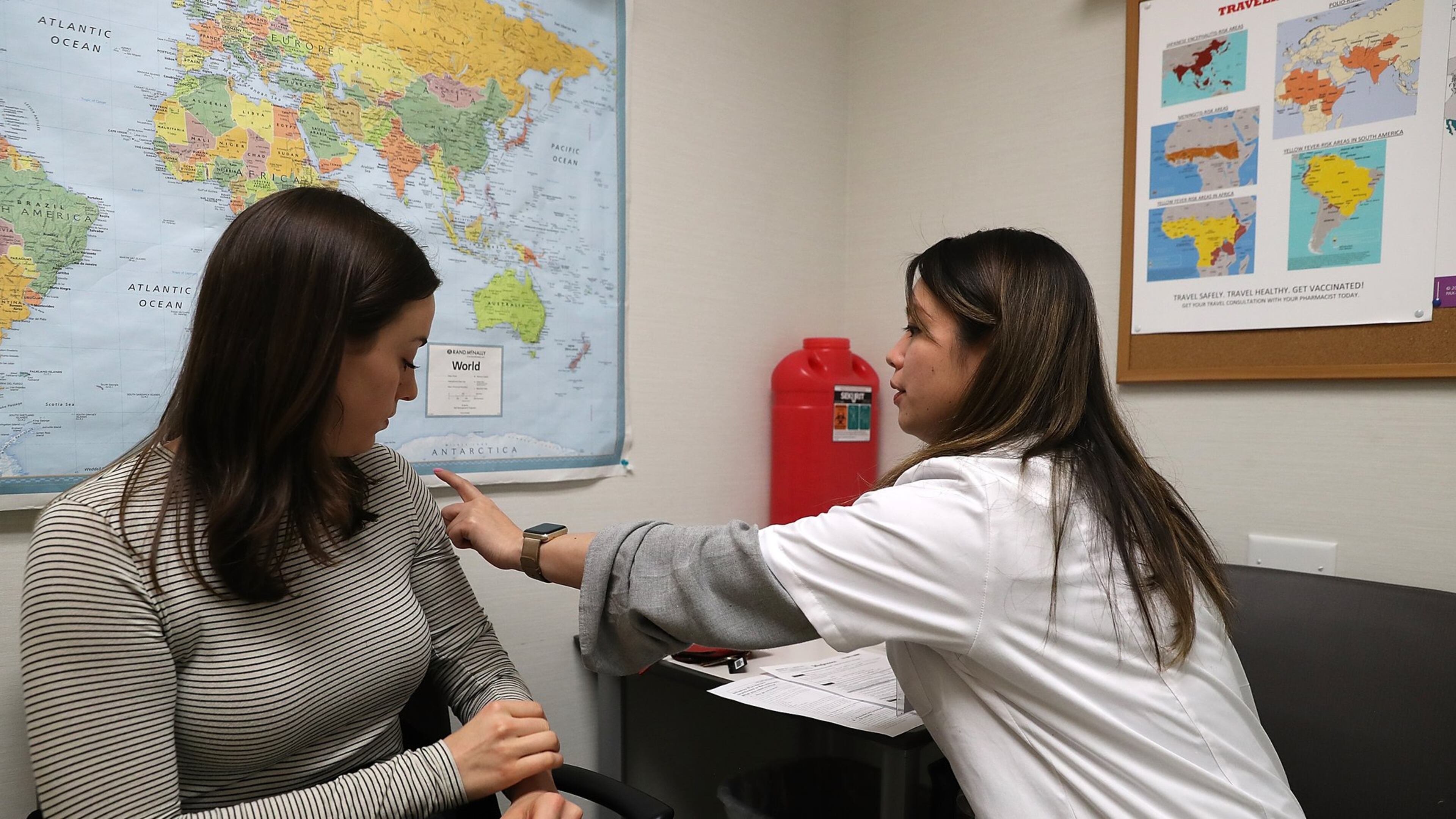 Even now, health officials recommend people get a flu shot. Shown here, Simone Groper prepares to receive a flu shot this season at a Walgreens pharmacy in San Francisco. (PHOTO by Justin Sullivan/Getty Images)