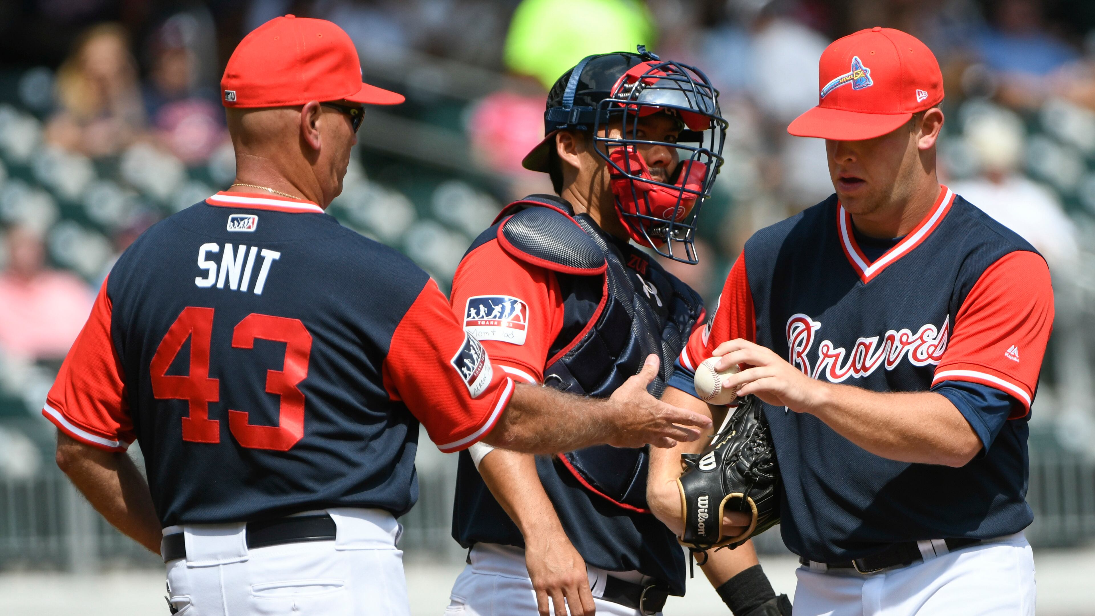Atlanta Braves pitcher A.J. Minter hands the ball to manager Brian Snitker (43) as he is relieved from the mound during the seventh inning of a baseball game against the Colorado Rockies, Sunday, Aug. 27, 2017, in Atlanta. Colorado won 3-0. (AP Photo/John Amis)