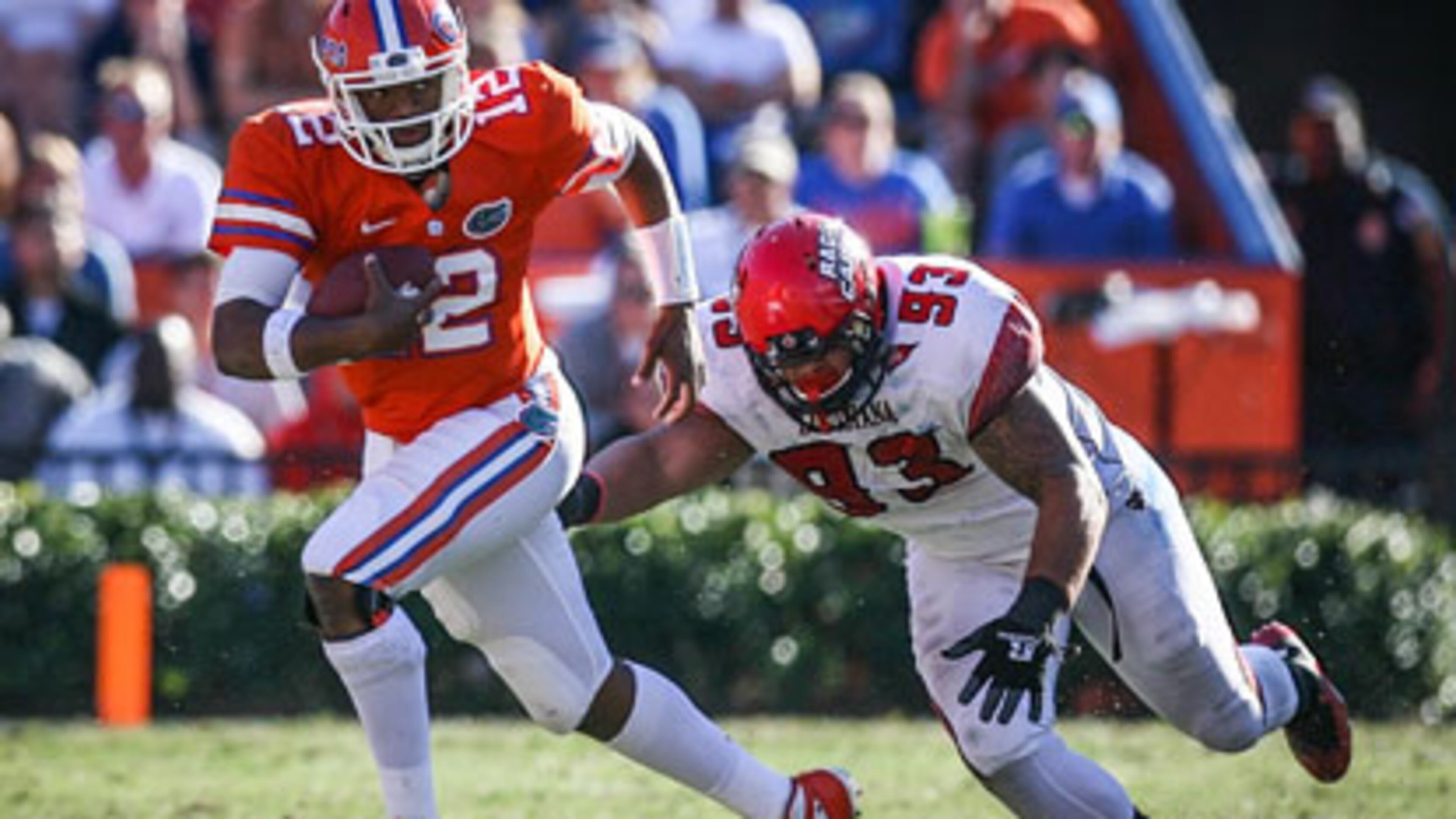 Florida quarterback Jacoby Brissett (12) evades Louisiana-Lafayette's Cordian Hagans (93) as he runs for yardage in the fourth quarter at Ben Hill Griffin Stadium on Saturday, November 10, 2012, in Gainesville, Florida. The host Gators rallied for a 27-20 win. (Joshua C. Cruey/Orlando Sentinel/MCT)