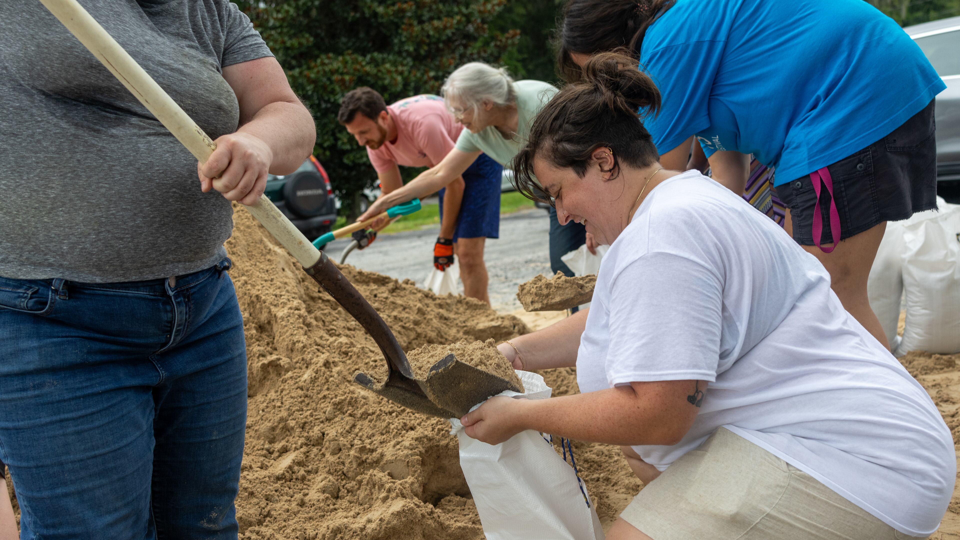 Renee Cowart helps Nikki Zuaro fill sand bags with sand at the Savannah Fire Station #7 on Sunday, August 4, 2024 in Savannah, GA. (AJC Photo/Katelyn Myrick)