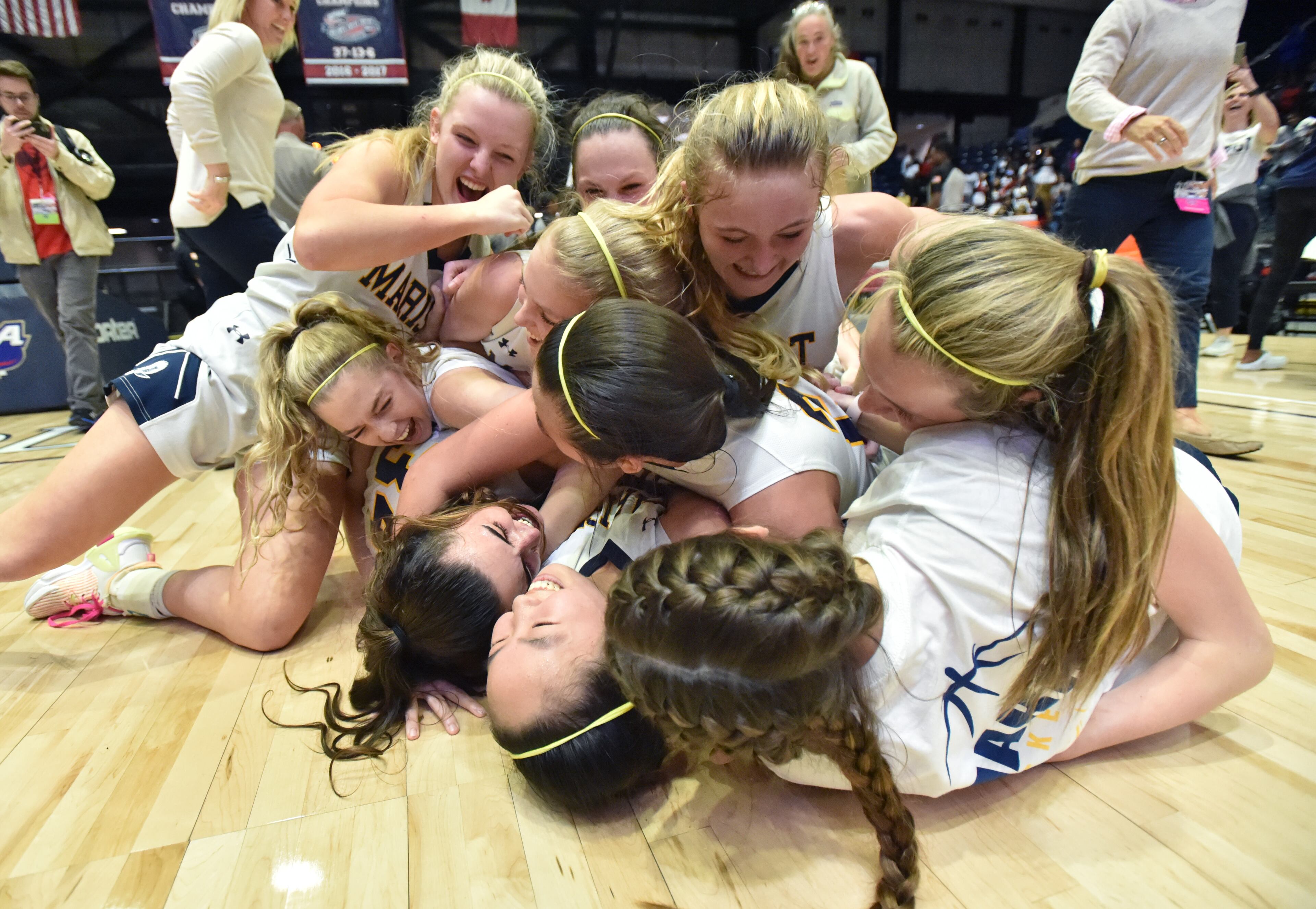 March 9, 2022 Macon - Marist's players celebrate their dramatic victory over Luella in double overtime during the 2022 GHSA State Basketball Championship game at the Macon Centreplex in Macon on Wednesday, March 9, 2022. Marist won 56-54 over Luella in overtime. (Hyosub Shin / Hyosub.Shin@ajc.com)