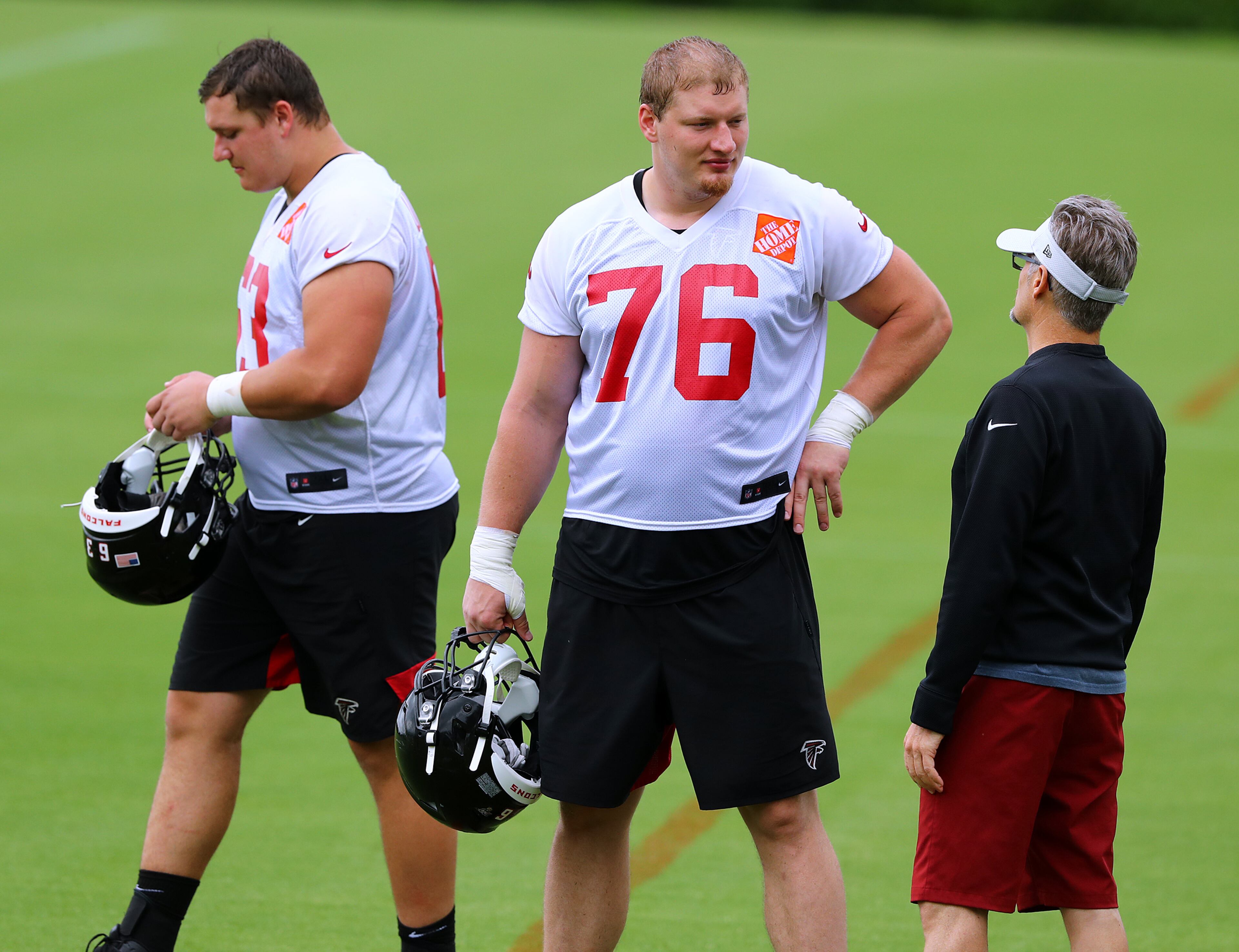 Falcons general manager Thomas Dimitroff confers with first round draft picks Kaleb McGary and Chris Lindstrom after practice. (Curtis Compton/ccompton@ajc.com).
