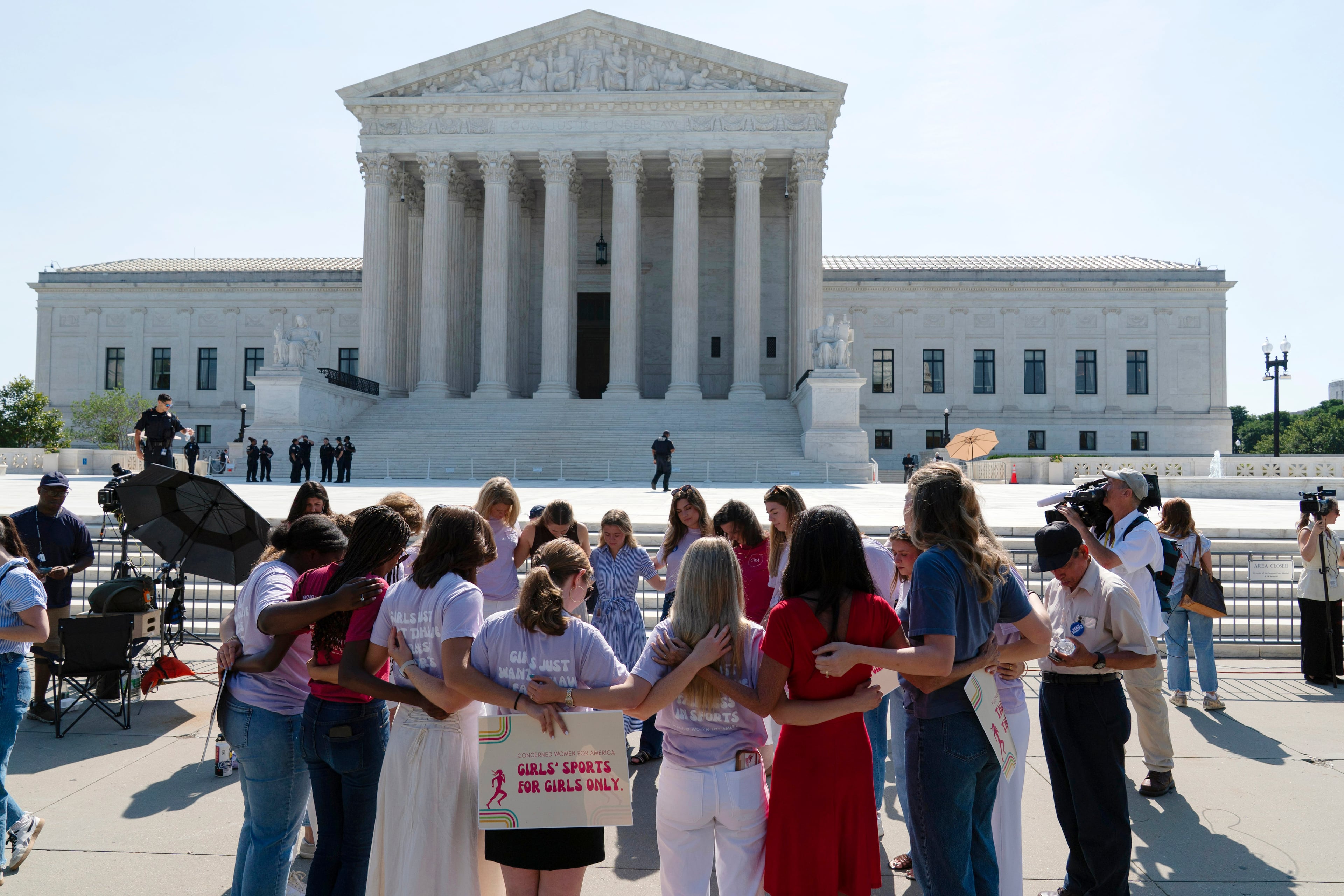 A group prays outside of the Supreme Court on Tuesday, June 30, 2026, ahead of the court's ruling on whether transgender girls and women can play on school athletic teams. Tuesday was the last day of the court's session, and several rulings were expected to be handed down. (Jose Luis Magana/AP)