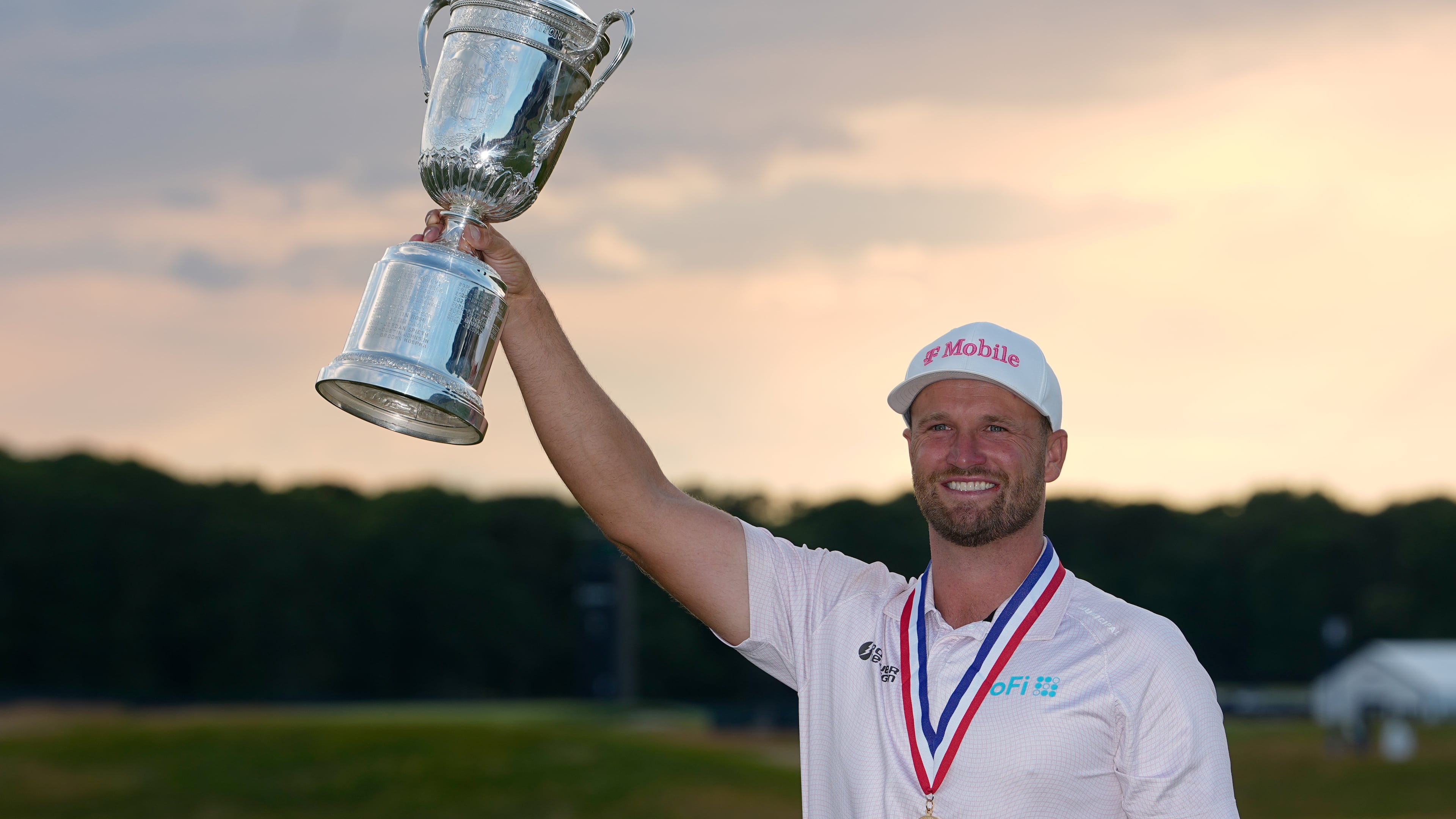 Wyndham Clark holds the trophy after winning the U.S. Open golf tournament at Shinnecock Hills Golf Club in Southampton, N.Y., Sunday, June 21, 2026. (AP Photo/Gerald Herbert)