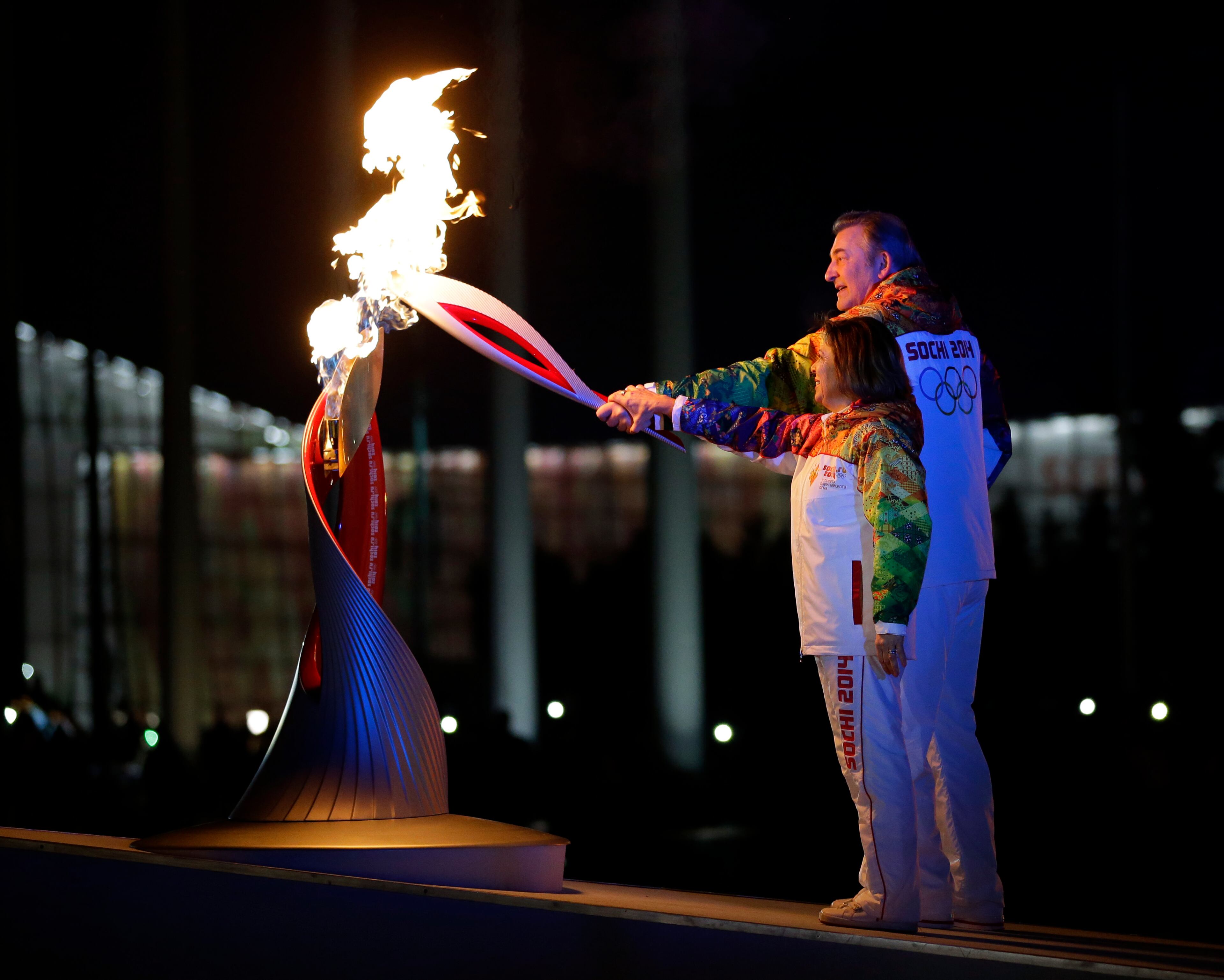 Irina Rodnina and Vladislav Tretyak light the Olympic cauldron during the opening ceremony of the 2014 Winter Olympics in Sochi, Russia, Friday, Feb. 7, 2014. (AP Photo/Matt Slocum, Pool)