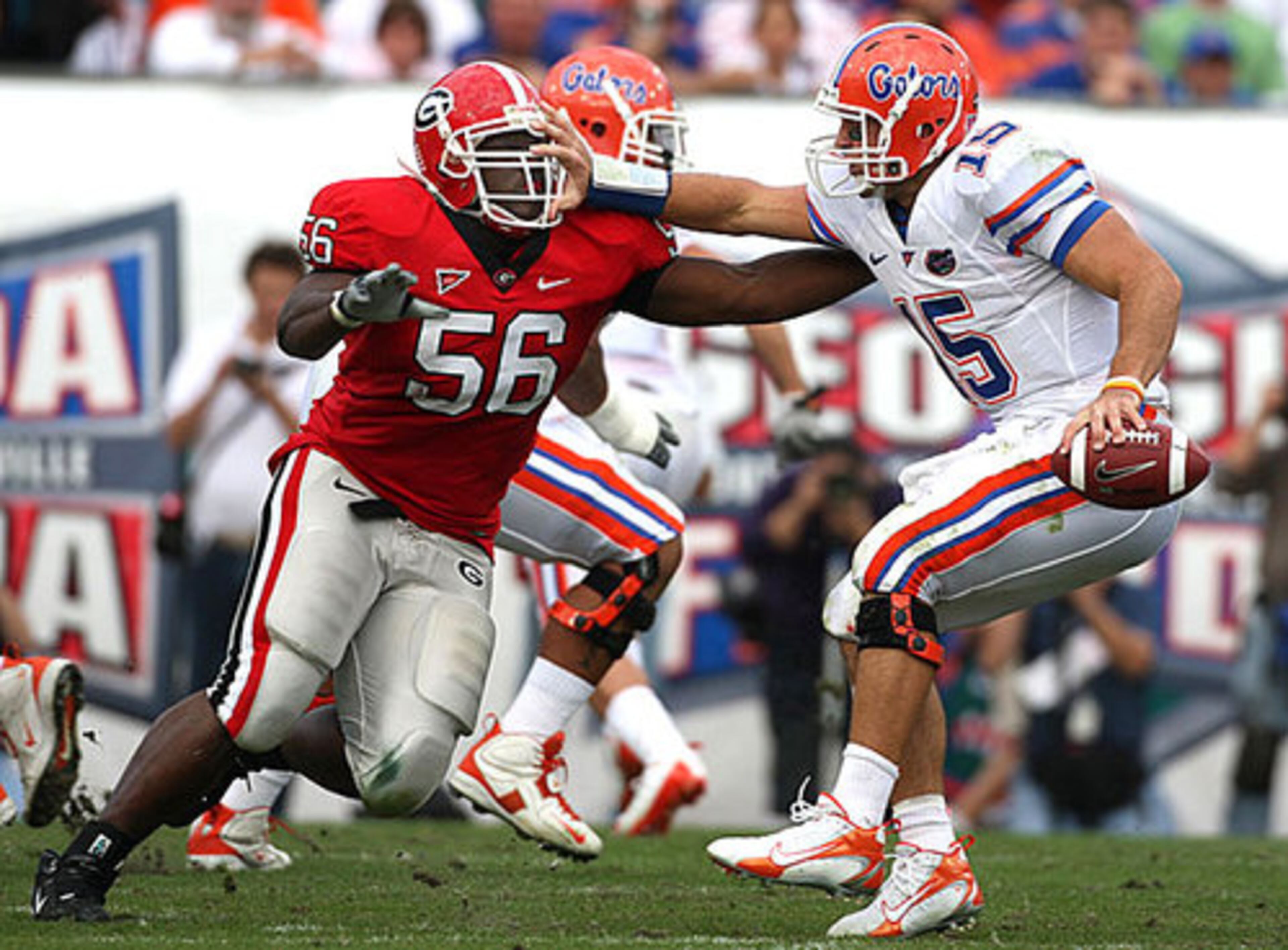 Tebow (15) tries to stop Georgia defensive tackle Geno Atkins (56) during the first half. Atkins was called for offsides on the play, one of many penalties that hurt the Bulldogs in the first half.