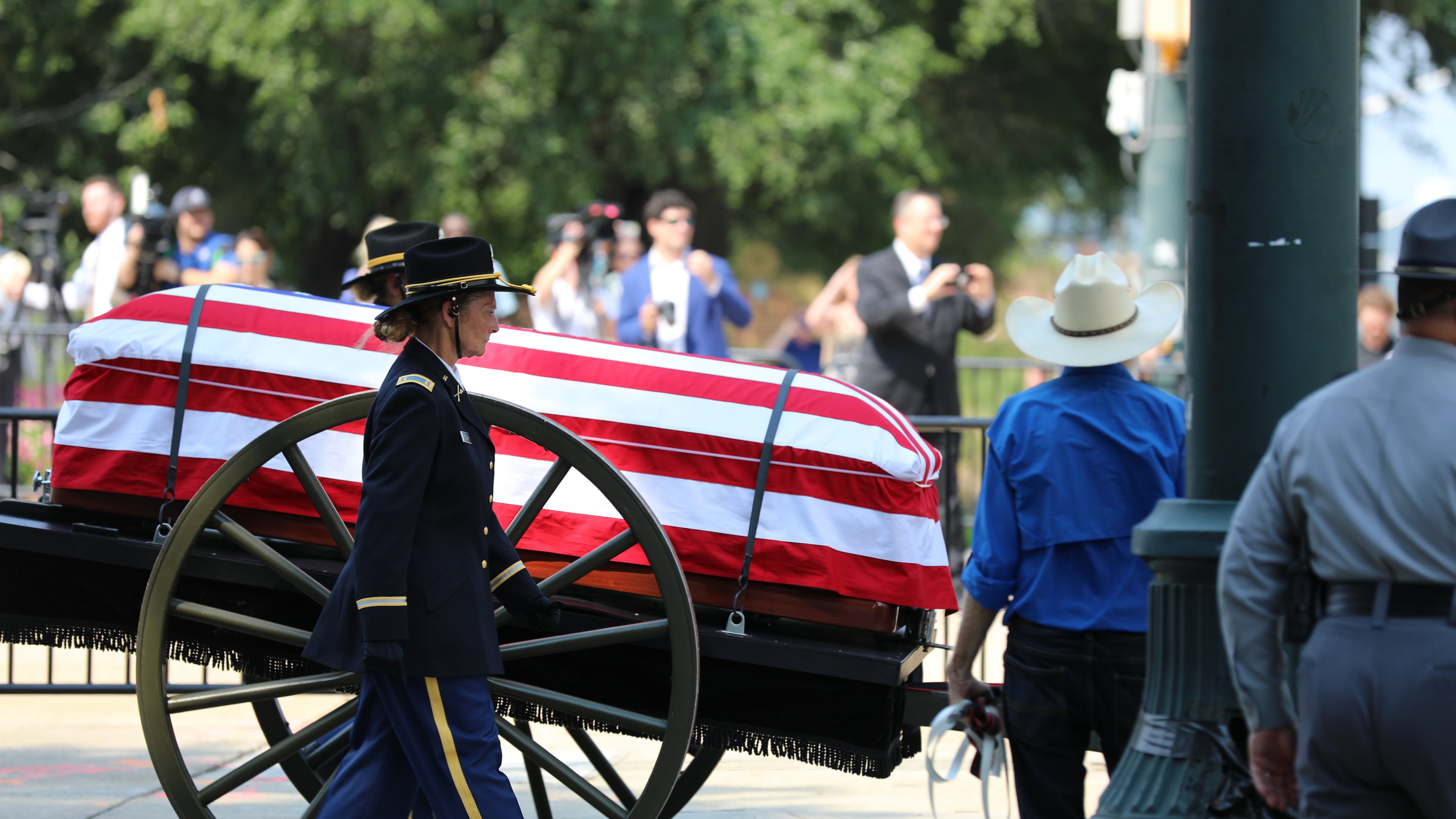 The flag-draped casket of U.S. Sen. Lindsey Graham, R-S.C., is carried on a horse-drawn caisson to his funeral at First Baptist Church in Columbia, S.C., on Wednesday, July 29, 2026. (AP Photo/Jeffrey Collins).
