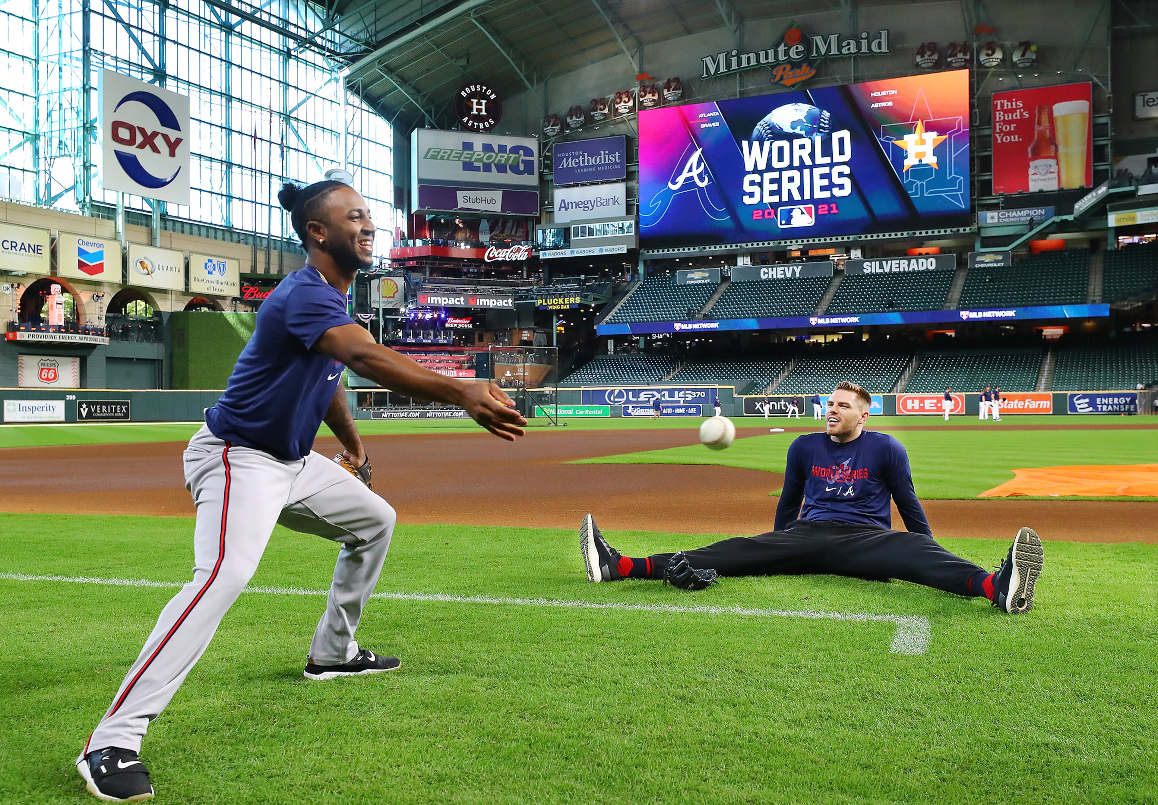 Braves second baseman Ozzie Albies (left) and first baseman Freddie Freeman share a laugh as they loosen up before playing the Astros in game 2 of the World Series on Wednesday, Oct. 27, 2021, in Houston. “Curtis Compton / Curtis.Compton@ajc.com”
