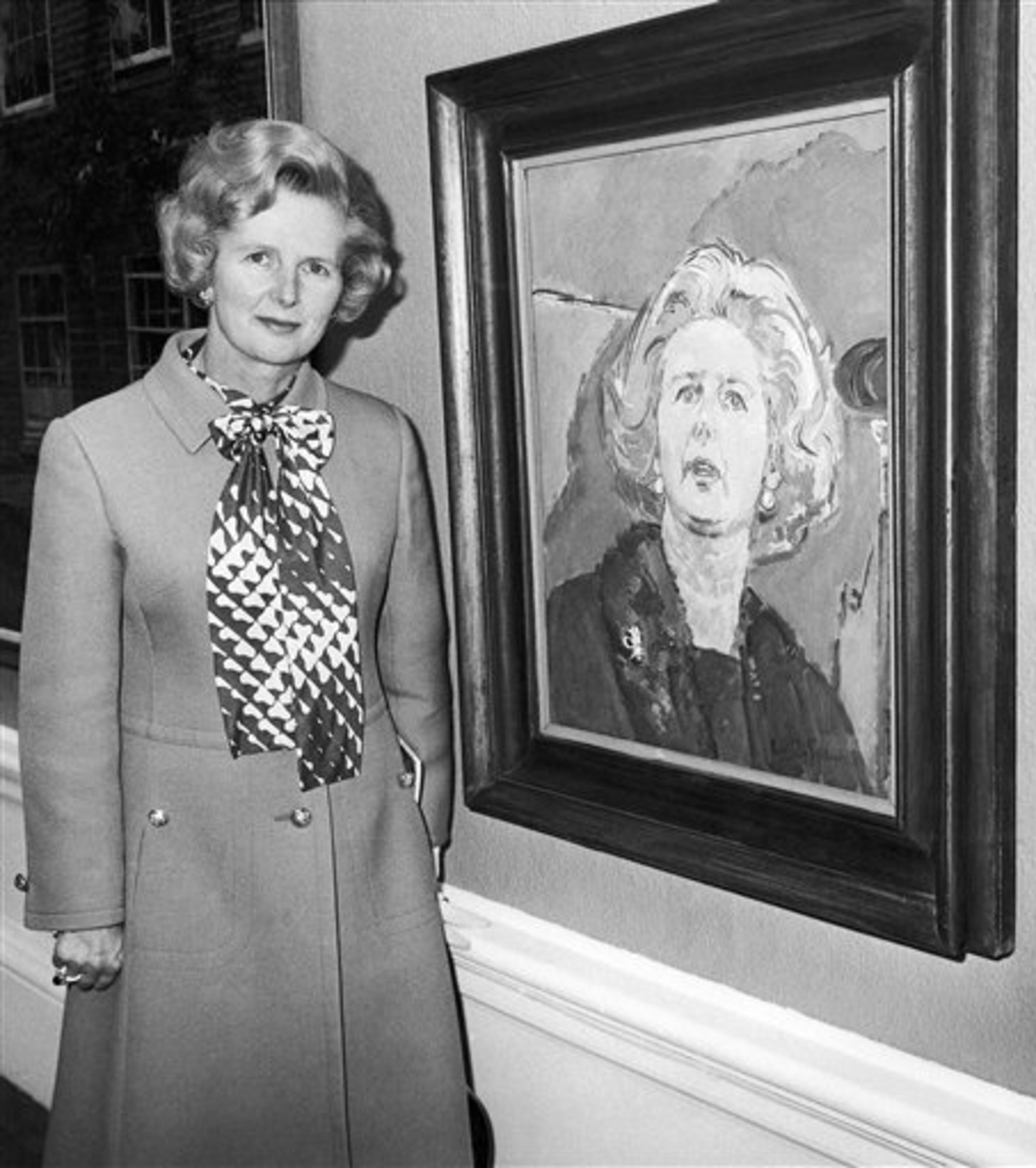 Opposition leader Margaret Thatcher stands with her portrait entitled ?True Blue? during a tour this afternoon of the Royal Academy?s Summer Exhibition in London, May 29, 1975. The portrait, in all blue, is by Ruskin Spear. (AP Photo/Press Association)