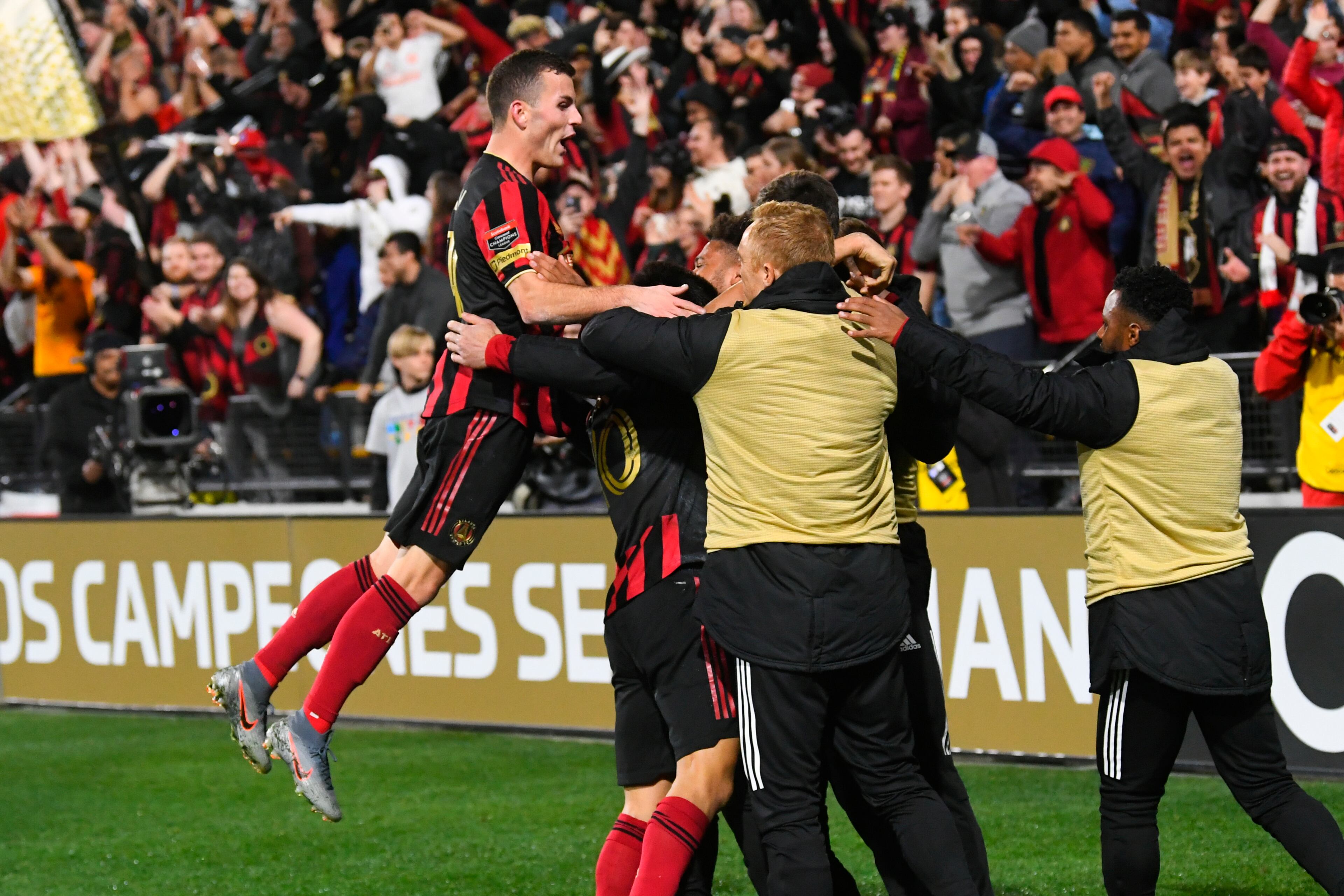 Atlanta United defender Brooks Lennon leaps to join the celebration of a goal by Gonzalo Martinez during the second half of a soccer match against Motagua FC in the Scotiabank Concacaf Champions League, Tuesday, Feb. 25, 2020, in Kennesaw, Ga. Atlanta United won 3-0. (John Amis, Atlanta Journal Constitution)