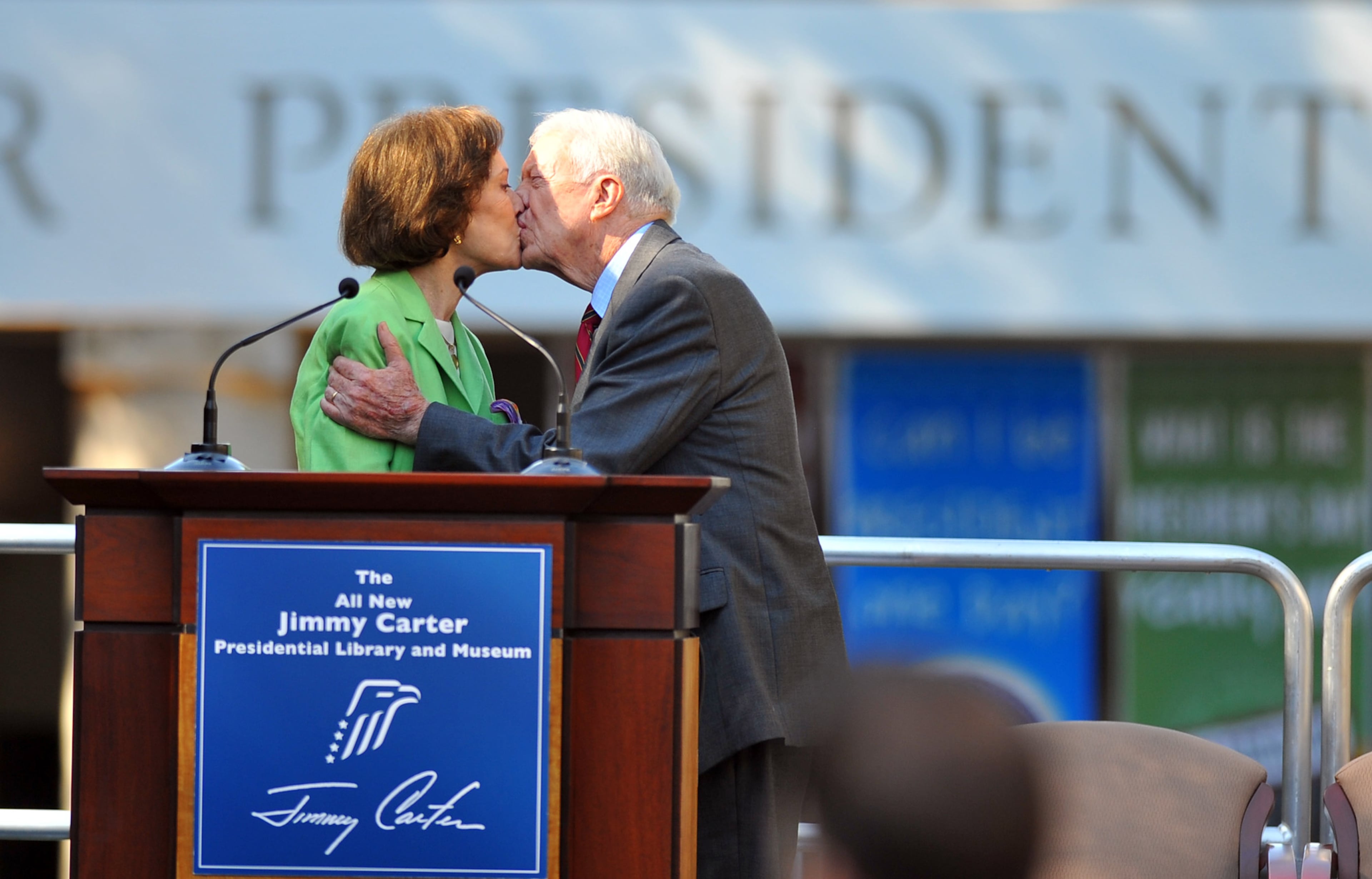 2009: Jimmy and Rosalynn Carter kiss during the reopening ceremony of the Carter Presidential Museum after a major five-month renovation. The event also marked Jimmy Carter's 85th birthday. (Brant Sanderlin / bsanderlin@ajc.com)