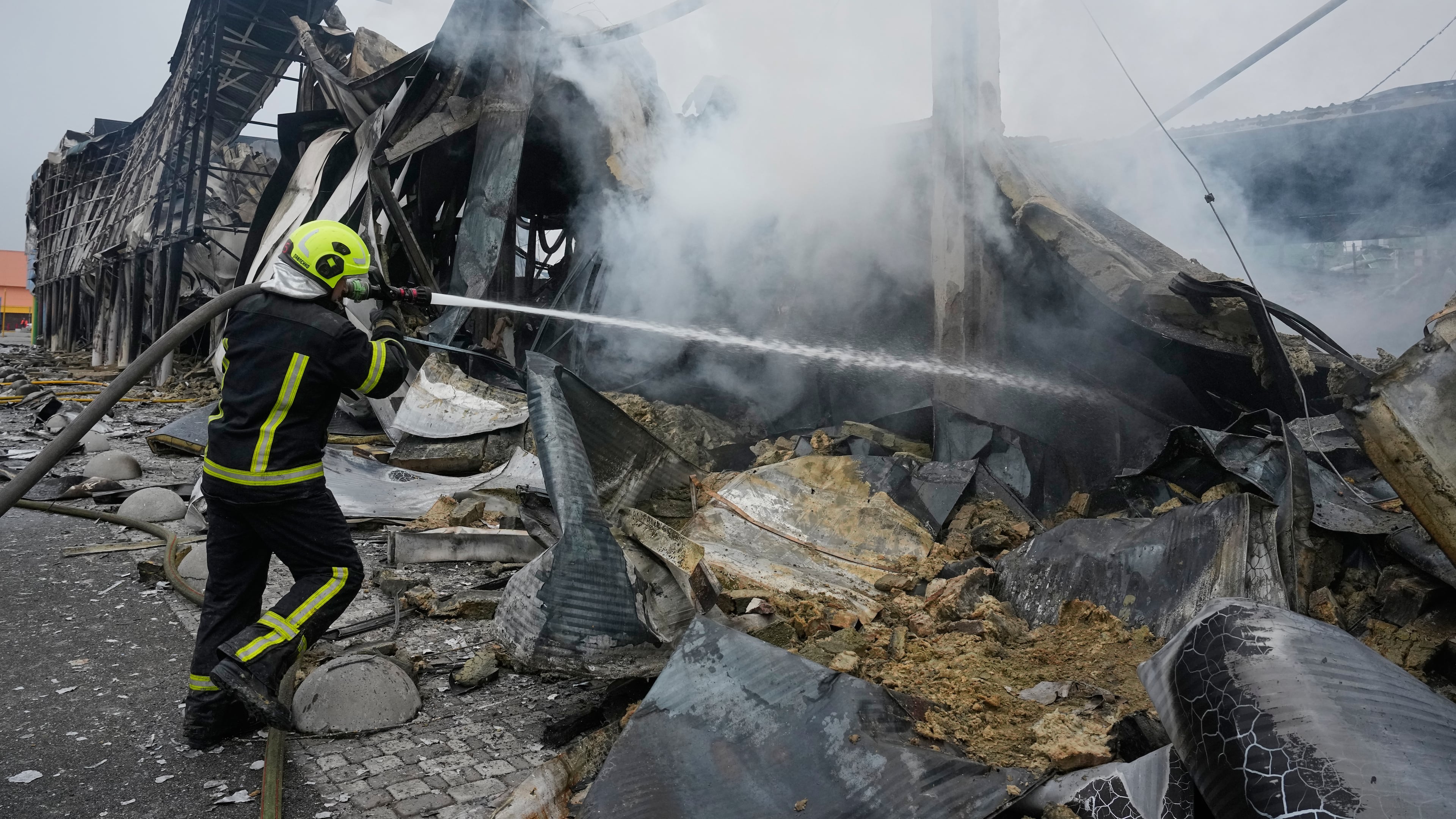 Firefighters try to extinguish a fire after a Russian missile attack in central Kyiv, Ukraine, Thursday, Oct. 22, 2026. (AP Photo/Efrem Lukatsky)