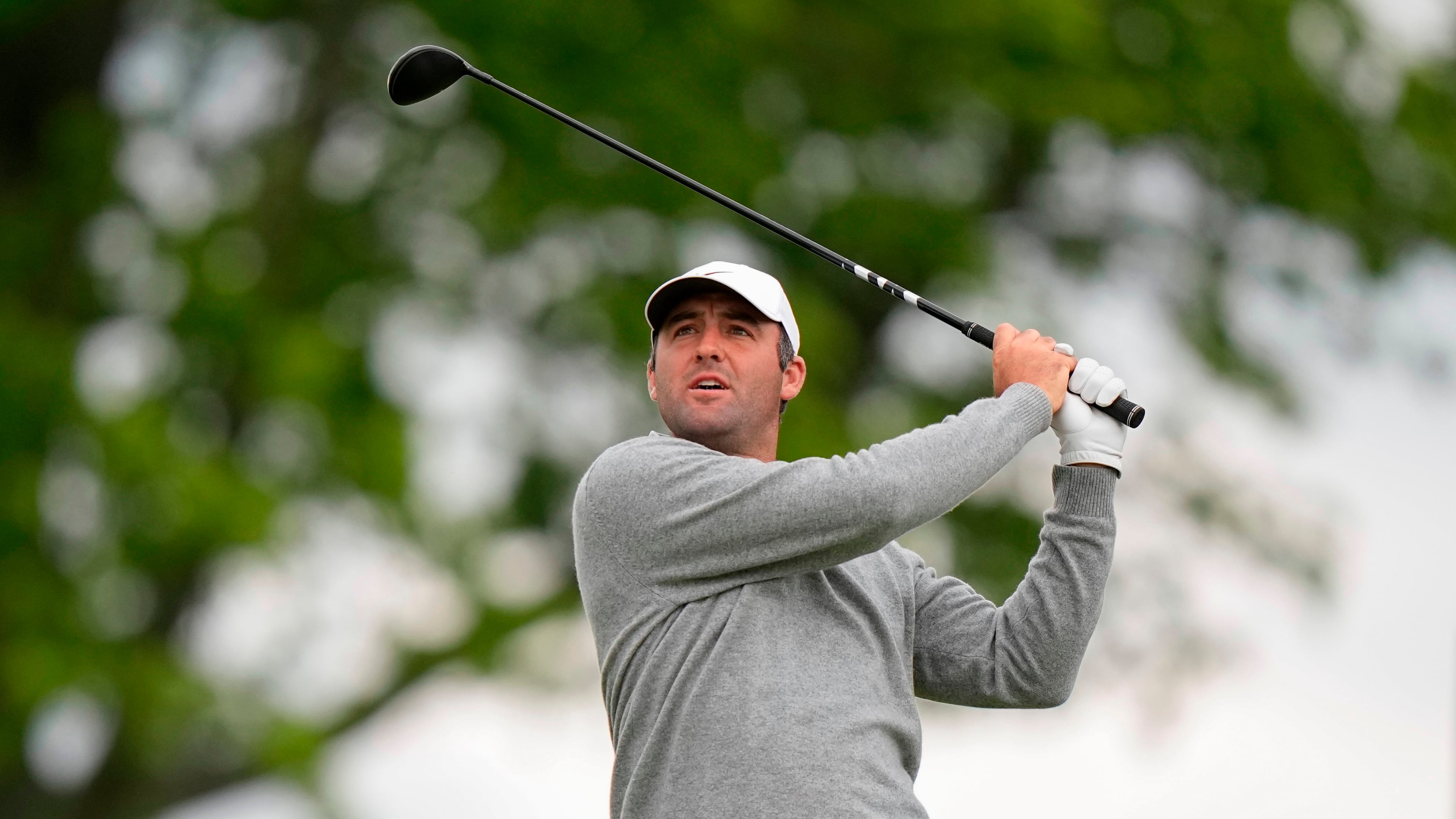 Fans watch Scottie Scheffler hits on the eighth green during the first round of the PGA Championship golf tournament at Aronimink Golf Club, Thursday, May 14, 2026, in Newtown Square, PA. (AP Photo/Frank Franklin II)