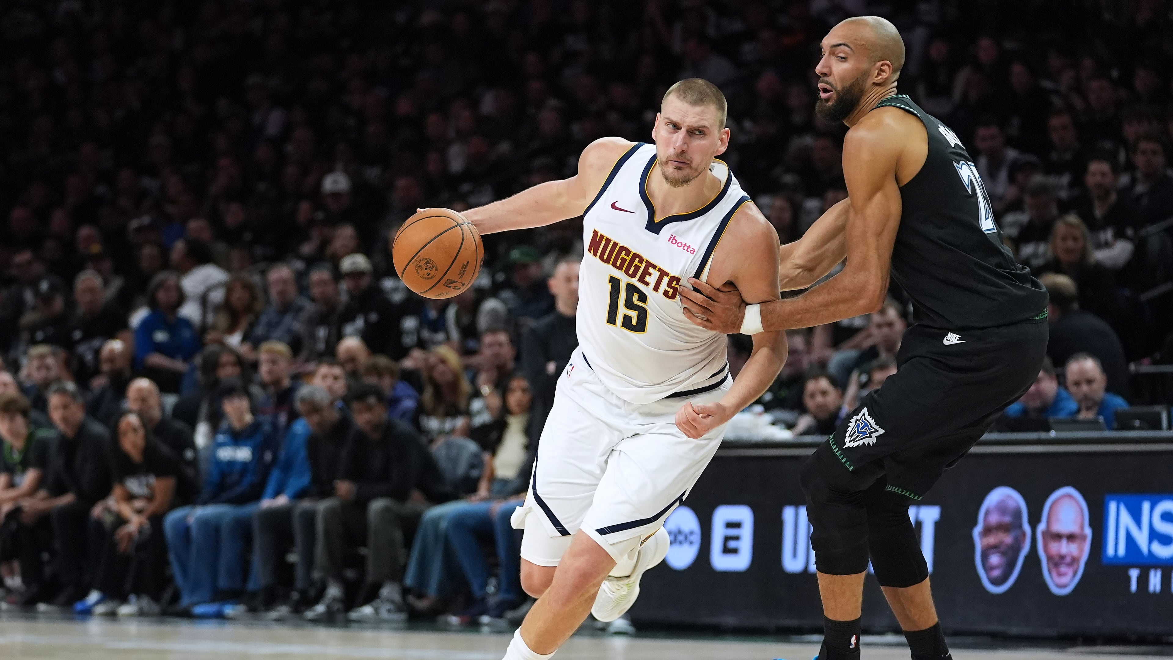 Denver Nuggets center Nikola Jokic (15) works toward the basket as Minnesota Timberwolves center Rudy Gobert, right, defends during the first half of Game 4 of a first-round NBA basketball playoff series, Saturday, April 25, 2026, in Minneapolis. (AP Photo/Abbie Parr)
