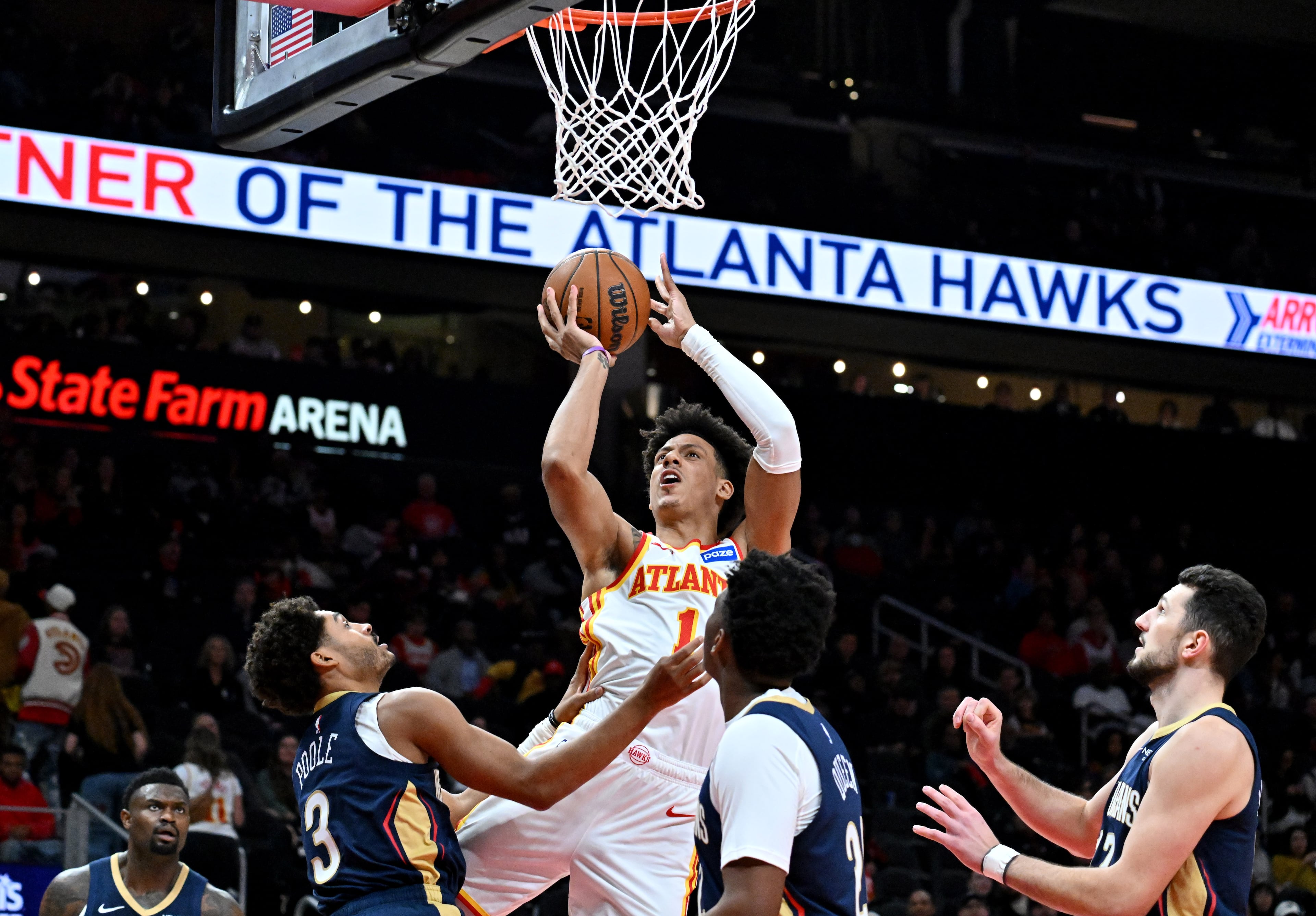 Atlanta Hawks forward Jalen Johnson (1) shoots over New Orleans Pelicans guard Jordan Poole (3) and New Orleans Pelicans center Derik Queen (22) during the first half in an NBA basketball game at State Farm Arena, Wednesday, Jan. 7, 2026, in Atlanta. (Hyosub Shin/AJC)