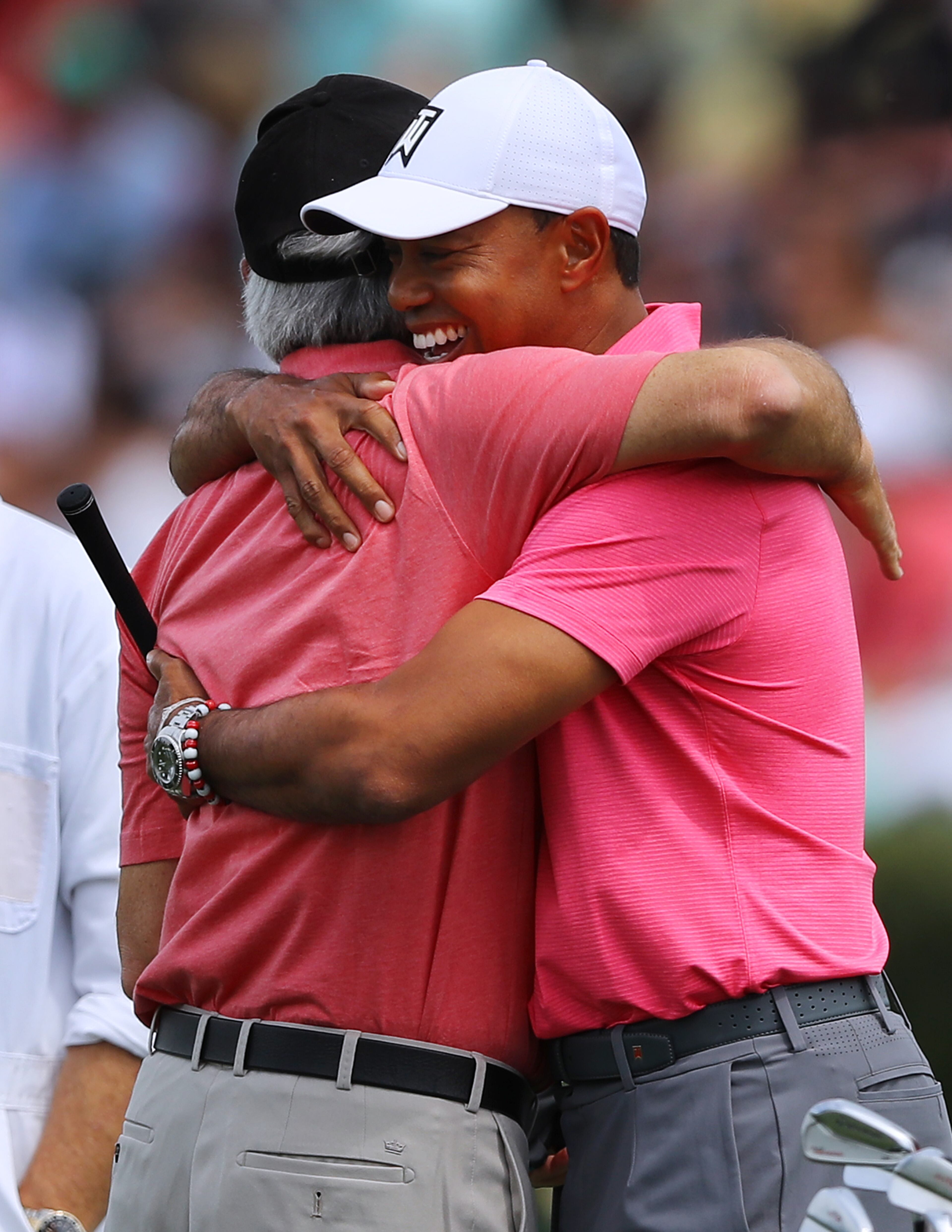 April 2, 2018 Atlanta: Tiger Woods gets a hug from Fred Couples as he arrives for the Masters on the practice range at Augusta National Golf Club on Monday, April 2, 2018, in Augusta. Curtis Compton/ccompton@ajc.com