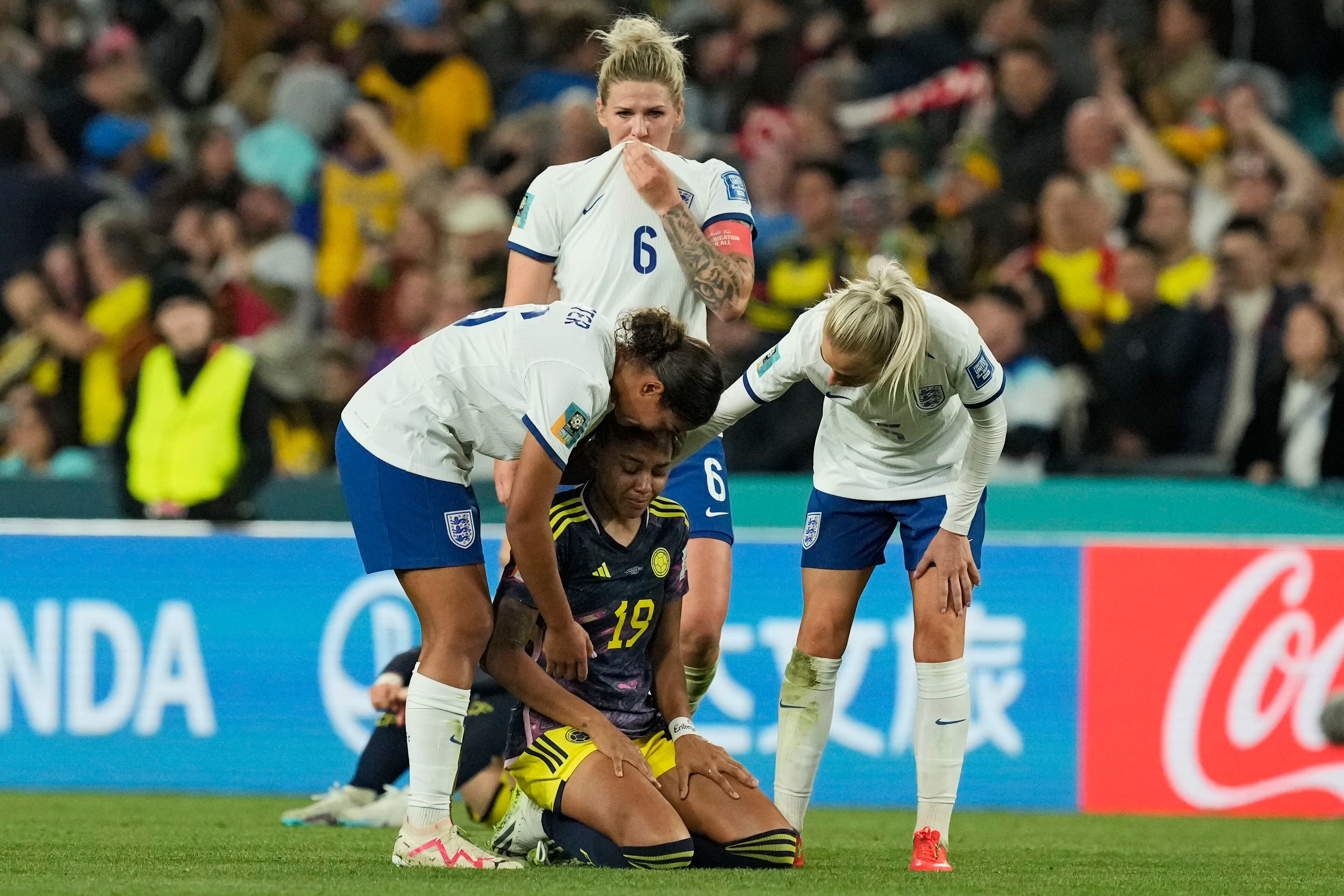 Colombia's Jorelyn Carabali is comforted by England's players after the Women's World Cup quarterfinal soccer match between England and Colombia at Stadium Australia in Sydney, Australia, Saturday, Aug. 12, 2023. (AP Photo/Mark Baker)