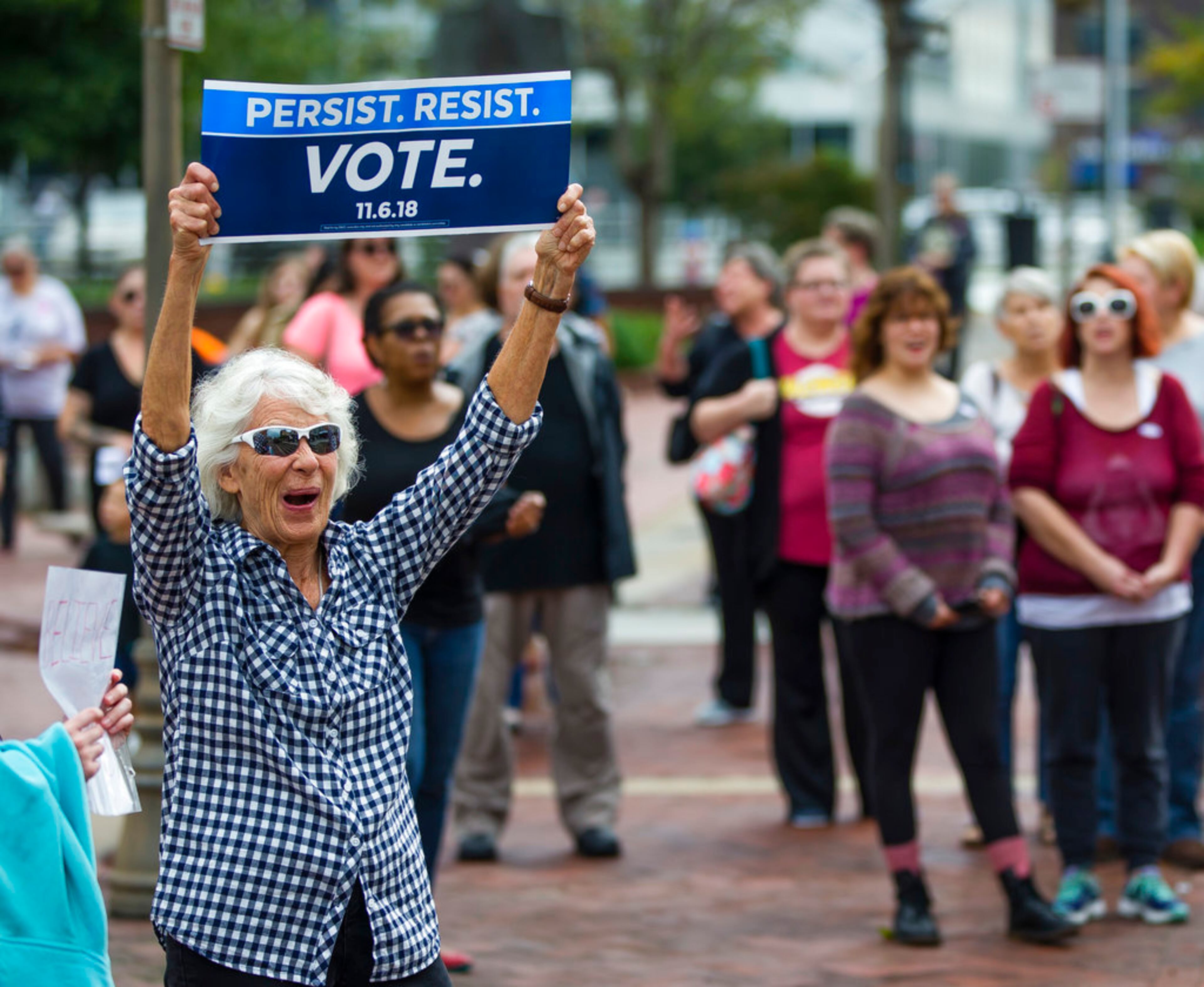 Jane Pitz holds up a sign during the We Believe Them rally Saturday, Oct. 6, 2018 at the Jon R. Hunt Plaza in downtown South Bend, Ind. (Michael Caterina/South Bend Tribune via AP)