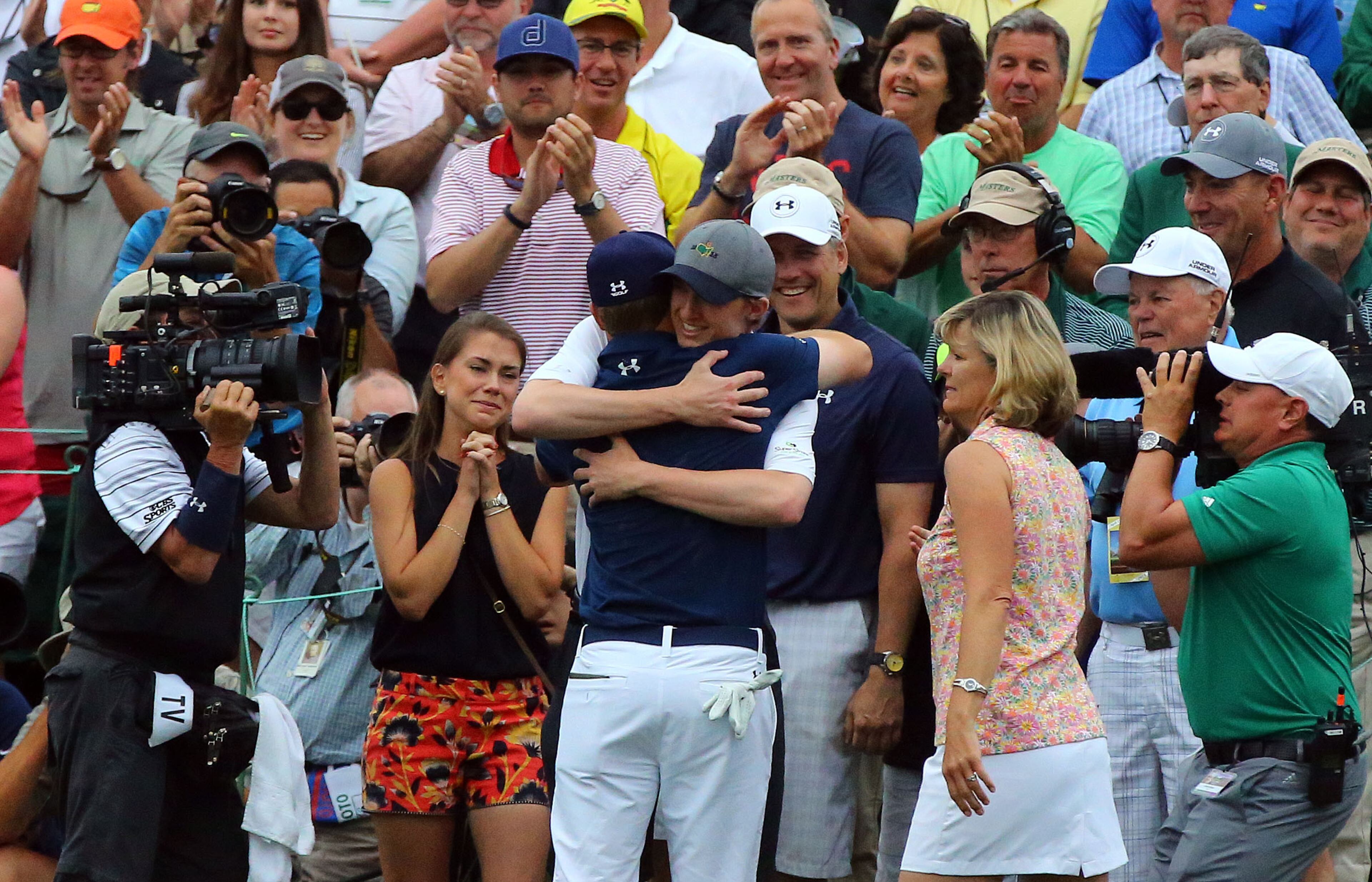 Jordan Spieth hugs his brother, Steven Spieth, after winning the Masters. His girlfriend, Annie Verret is at left. Photos from the final round at the Masters Golf Tournament, Sunday, April 12, 2015. CURTIS COMPTON/CCOMPTON@AJC.COM