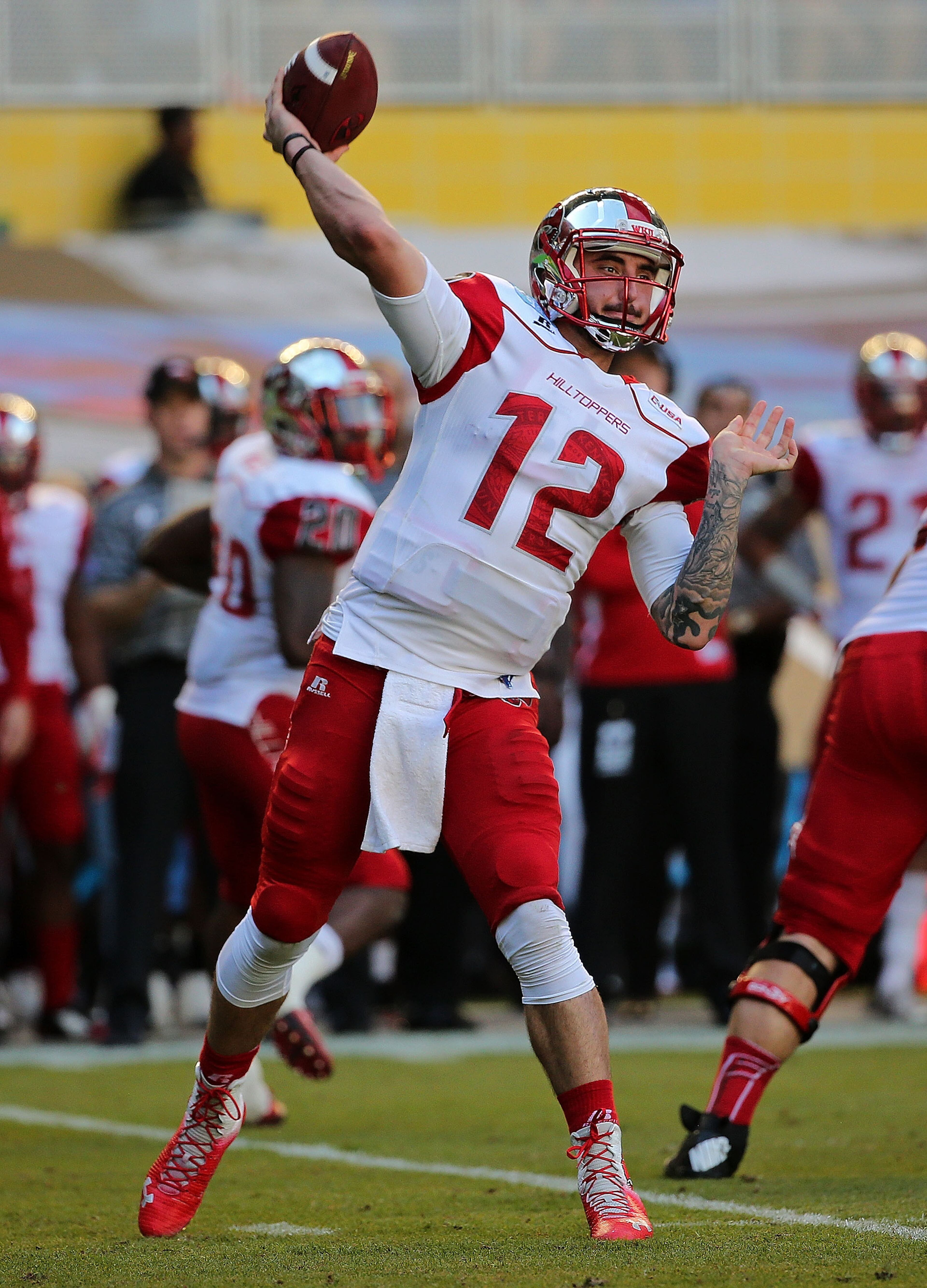 MIAMI, FL - DECEMBER 21: Brandon Doughty #12 of the Western Kentucky Hilltoppers passes during the 2015 Miami Beach Bowl against the South Florida Bulls at Marlins Park on December 21, 2015 in Miami, Florida. (Photo by Mike Ehrmann/Getty Images)