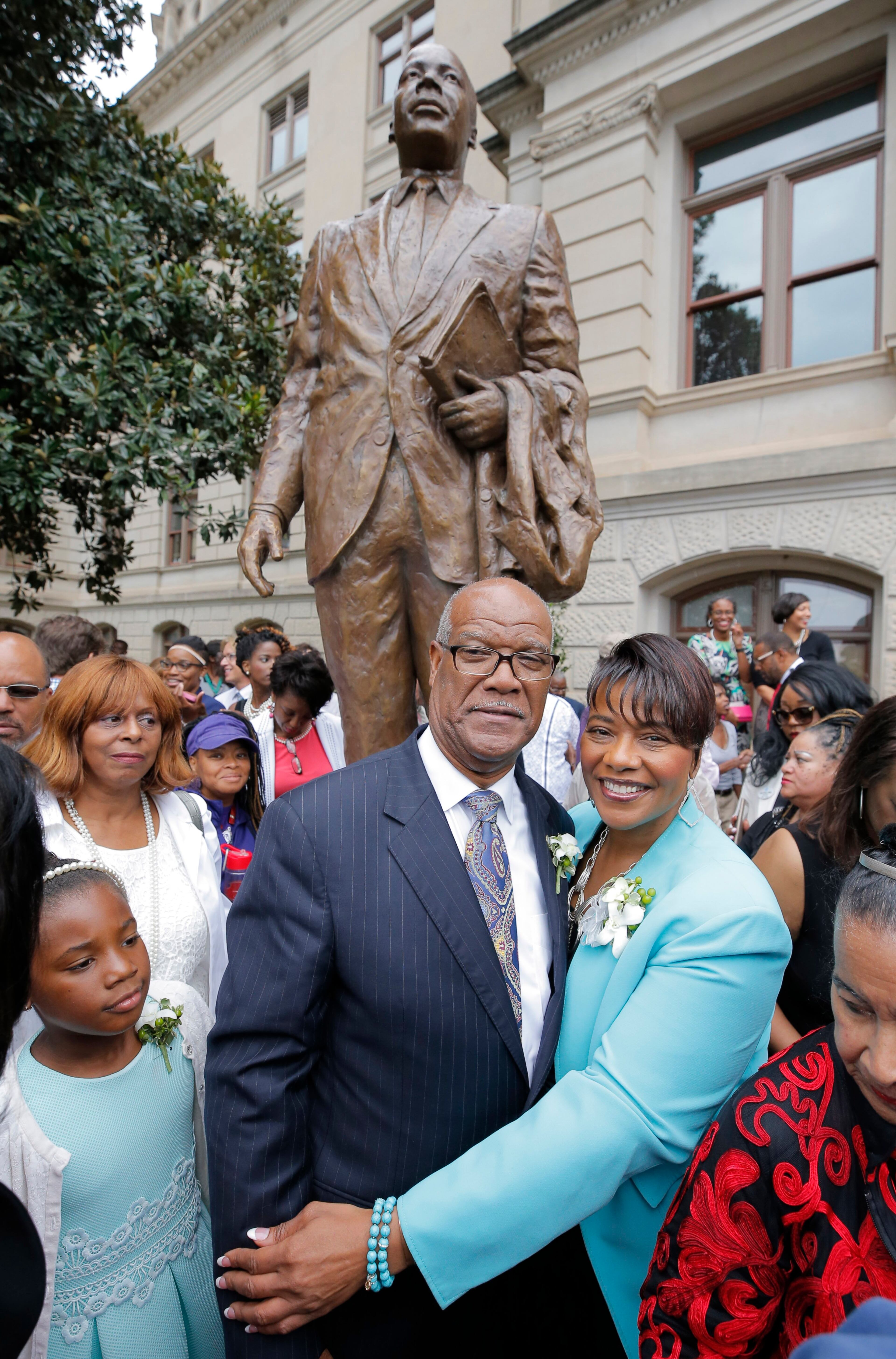 State Rep. Calvin Smyre, who played a roll in getting the statue, the Rev. Bernice King and other members of the King family gathered around the statue Monday. BOB ANDRES /BANDRES@AJC.COM