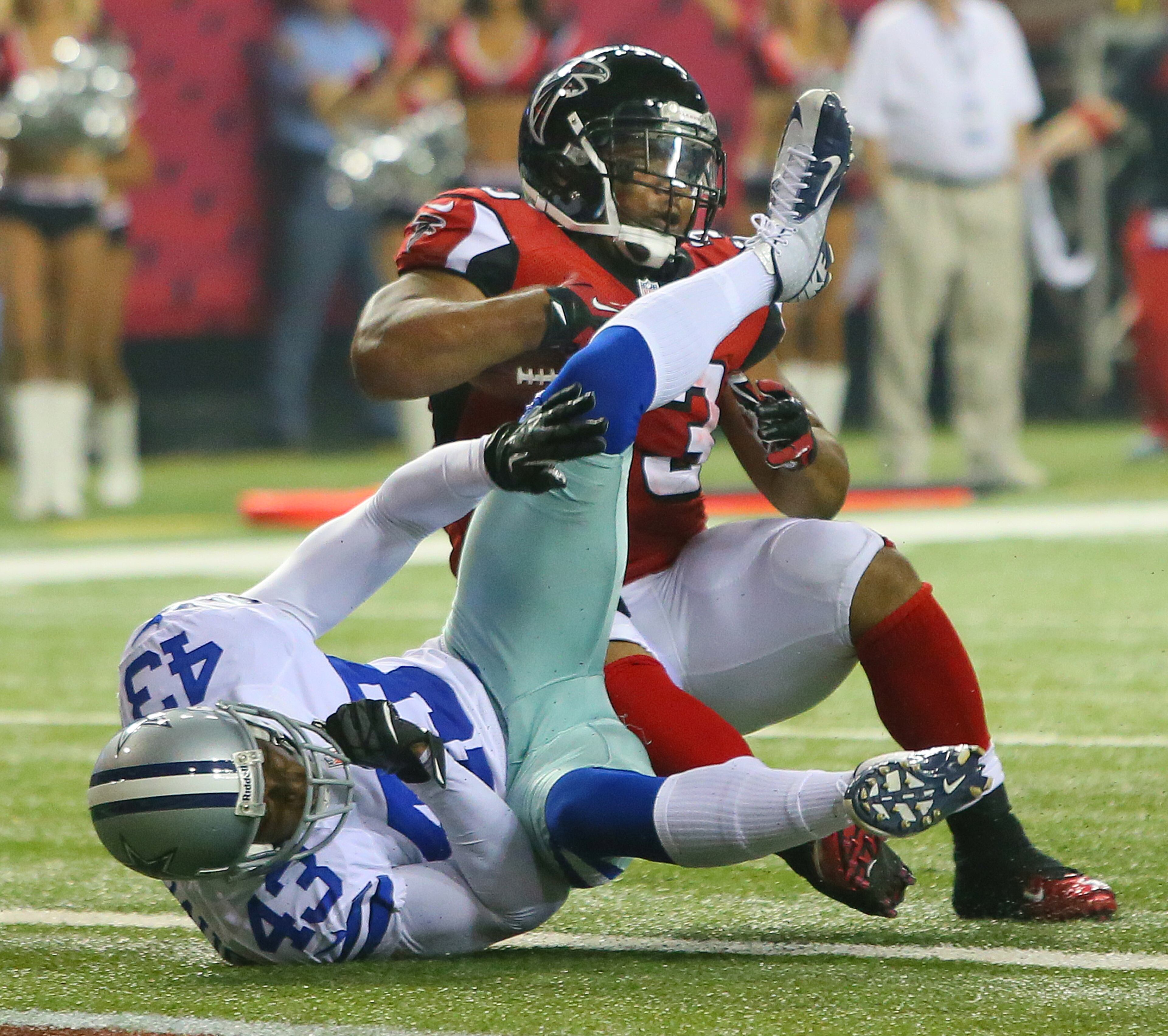 Falcons running back Michael Turner caps an 81-yard drive leveling Cowboys defender Gerald Sensabaugh at the goal line driving into the endzone for a touchdown and a 13-6 lead during fourth quarter action at the Georgia Dome in Atlanta on Sunday, Nov. 4, 2012. CURTIS COMPTON / CCOMPTON@AJC.COM