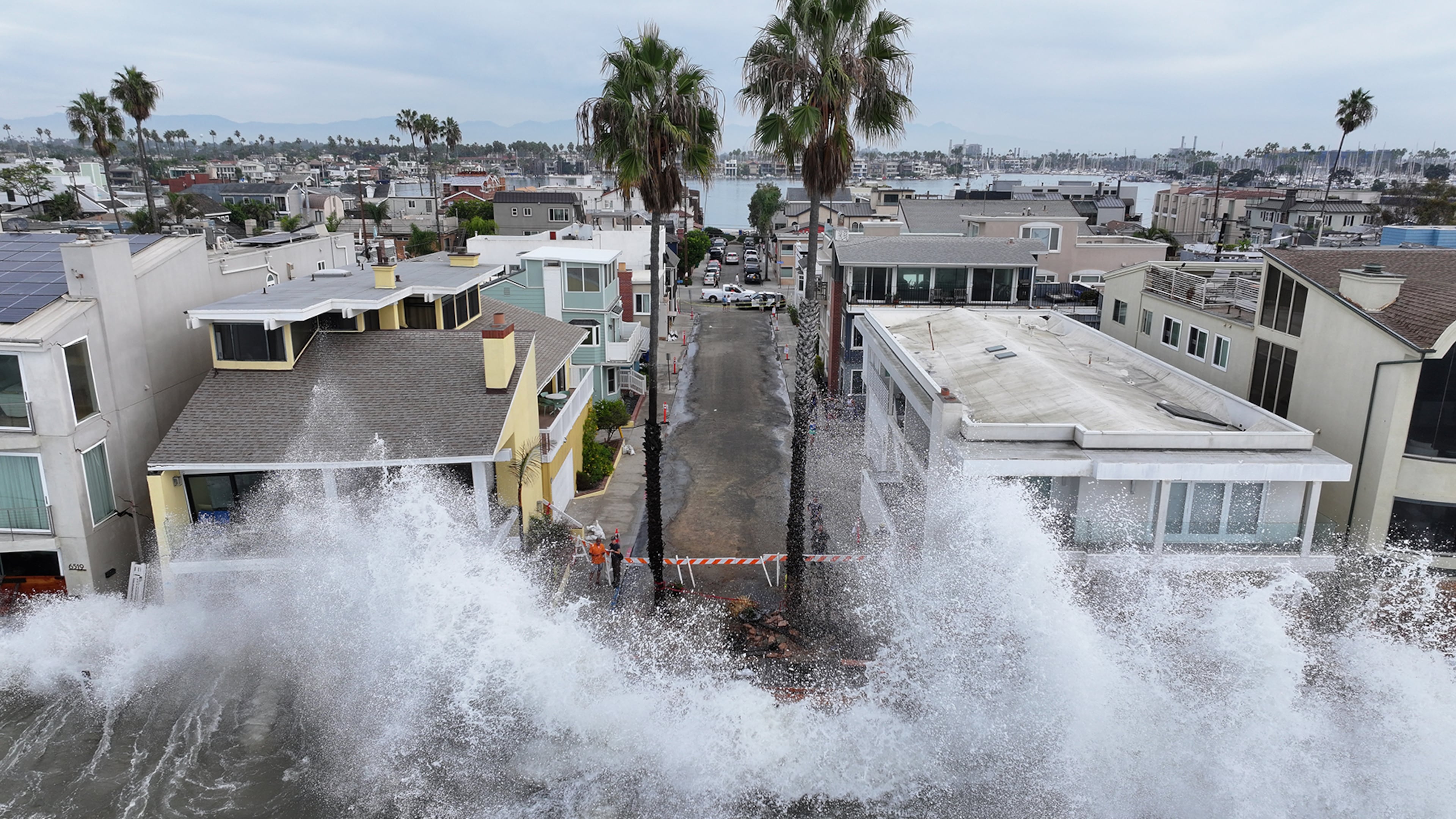 Waves hit a walkway in front of homes in Long Beach, Calif., Saturday, Oct. 10, 2026, as Tropical Storm Rachel approaches. (AP Photo/William Liang)
