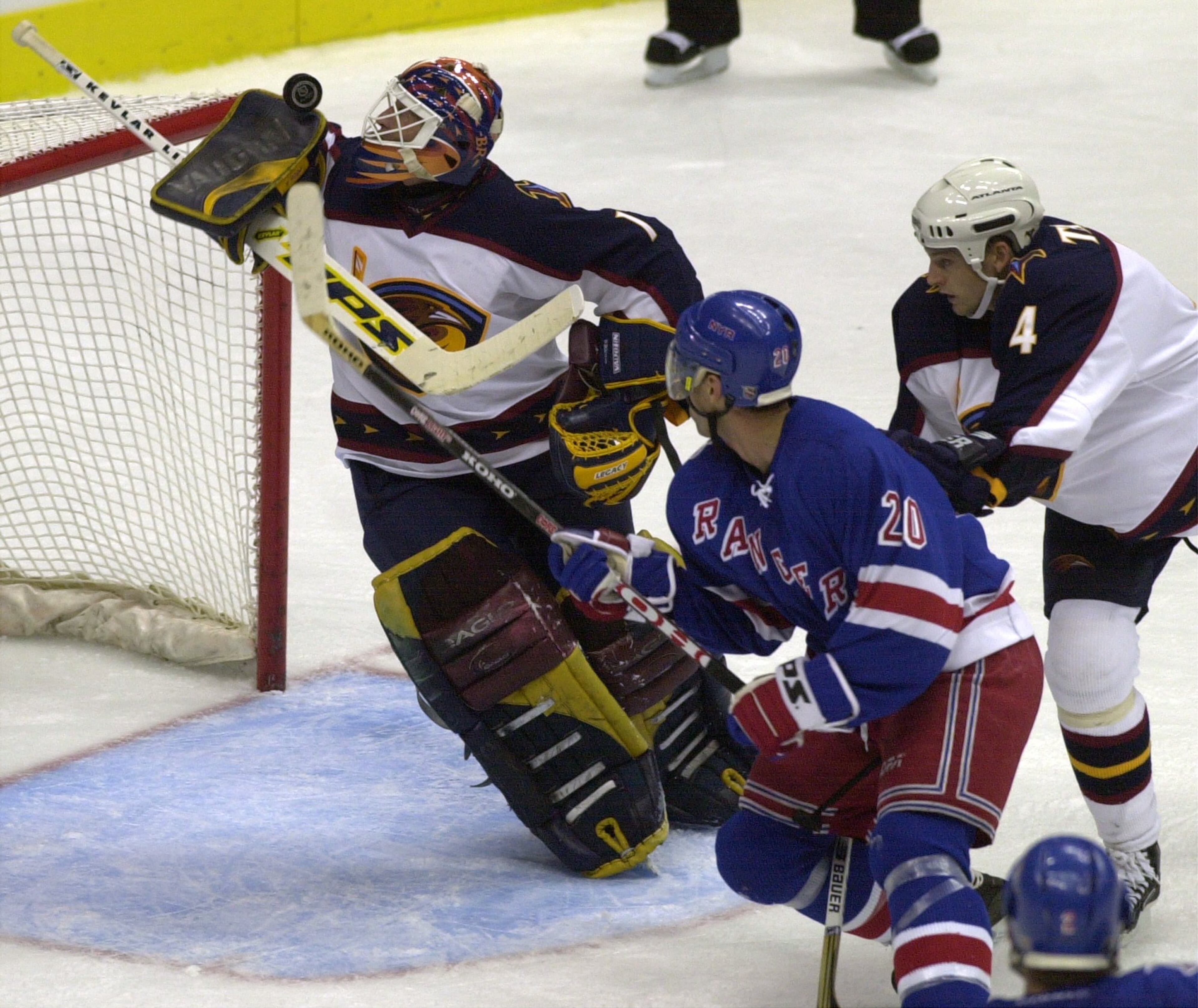 Atlanta Thrashers' goaltender Damian Rhodes #1 successfully blocks a shot from New York Rangers' Radek Dvorak as Thrashers' Chris Tamer looks on Saturday night at Philips Arena. (SUNNY SUNG/AJC STAFF)