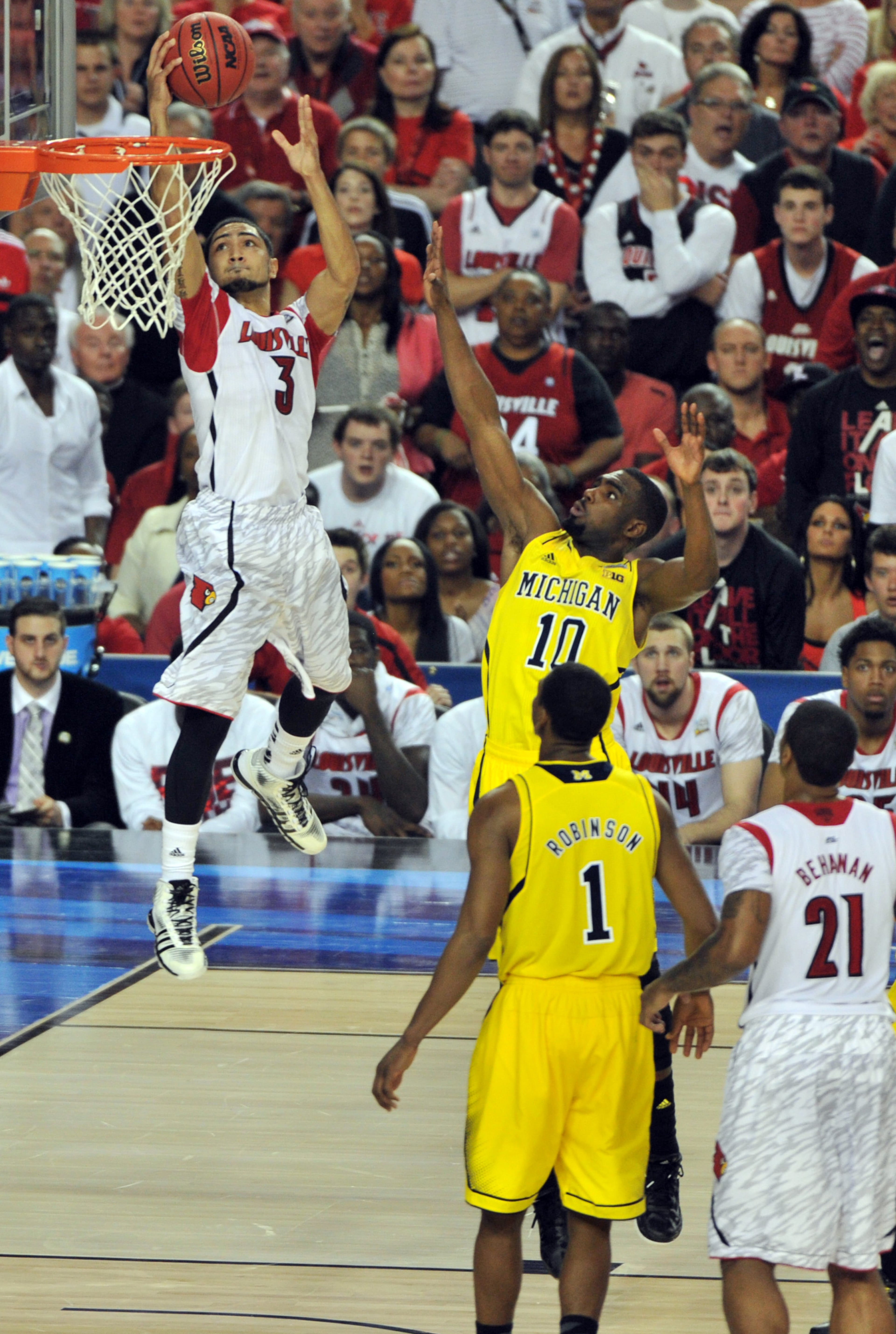 April 8, 2013 Atlanta - Louisville Cardinals guard Peyton Siva (3) goes to the basket past Michigan Wolverines guard Tim Hardaway Jr. (10) in the second half during NCAA Final Four Championship Game at Georgia Dorm in Atlanta on Monday, April 8, 2013. Louisville Cardinals defeated Michigan Wolverines 82-76. HYOSUB SHIN / HSHIN@AJC.COM