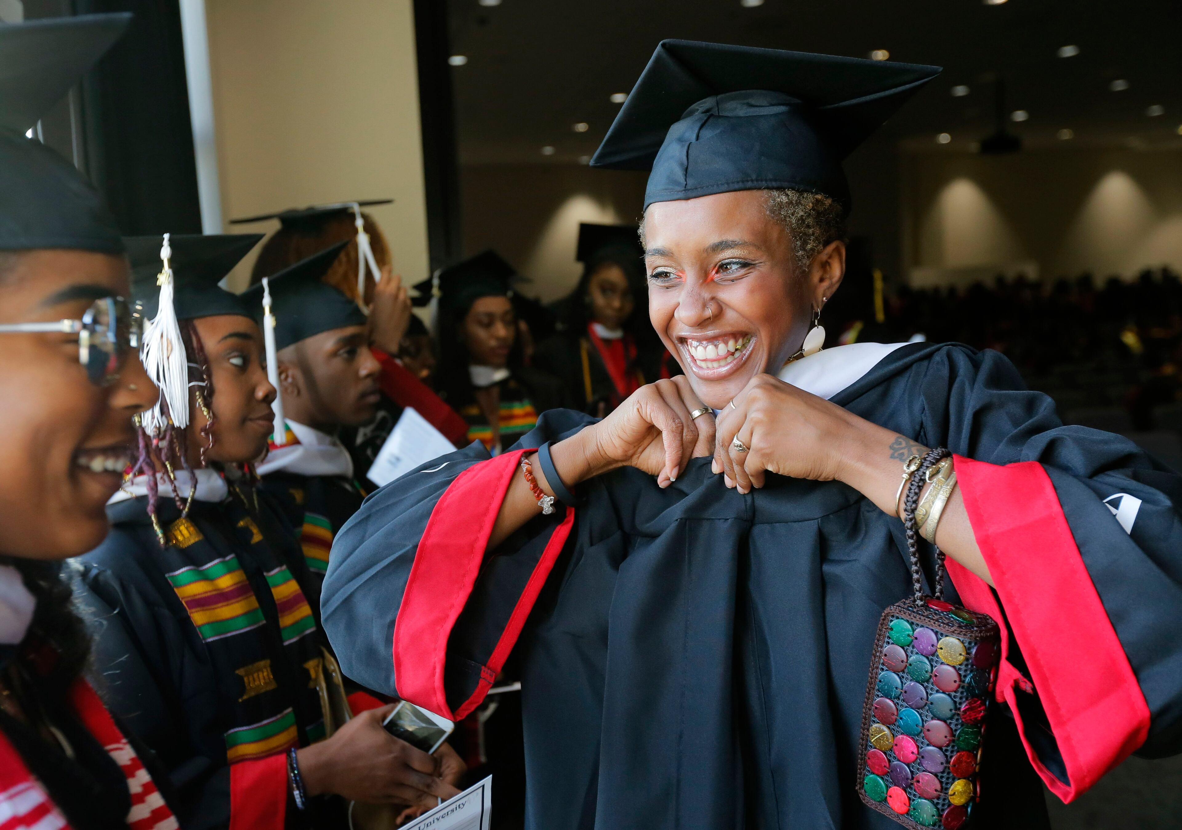 5/22/17 - Atlanta - Andrece Brady gets ready for the procession with other graduates. Clark Atlanta University's Panther Stadium was the site of their 28th annual Commencement. Businessman William Pickard gave the commencement address. Rev. Jesse Jackson, who received an honorary degree, also spoke. Panther Stadium, BOB ANDRES /BANDRES@AJC.COM