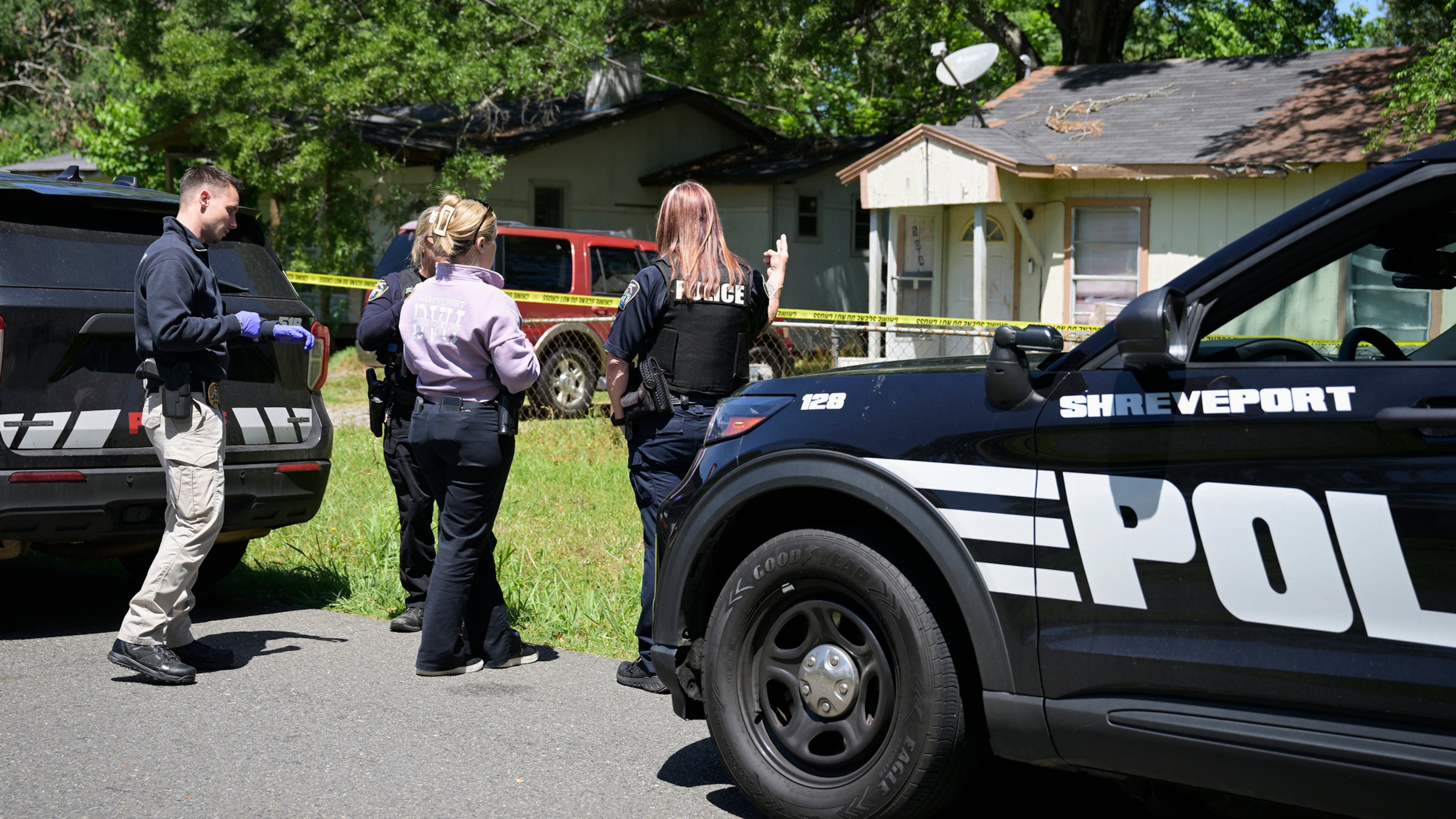 Police gather in front of a house on Harrison Street near Bernstein Avenue, in Shreveport, La., as they investigate a mass shooting, Sunday, April 19, 2026. (Jill Pickett/The Times-Picayune/The New Orleans Advocate via AP)