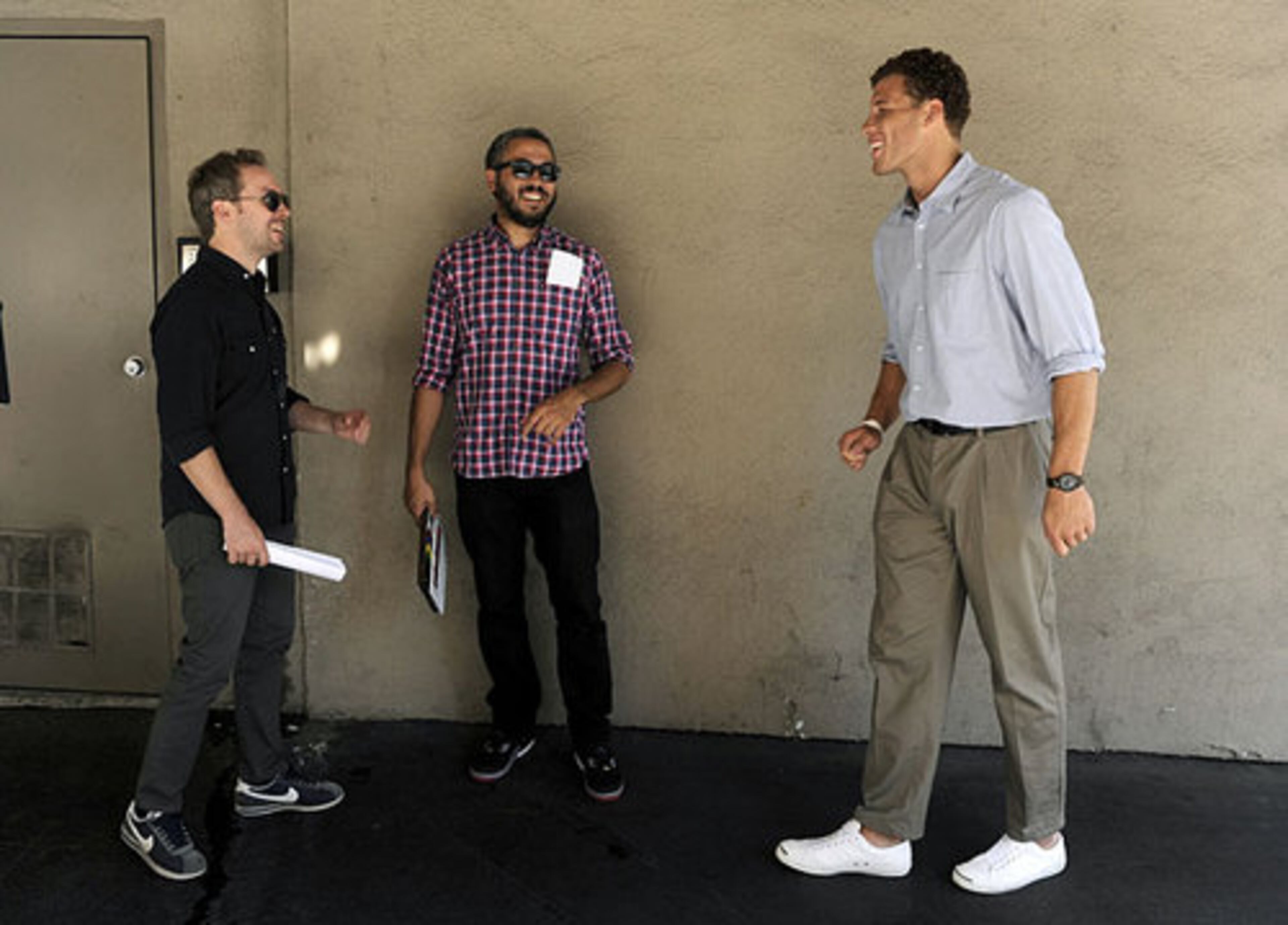 Los Angeles Clippers basketball player Blake Griffin, right, shares a laugh with co-directors Matt Villines, left, and Oz Rodriguez between takes. A fan of Funny Or Die and comedy in general, Griffin will spend the week on tasks ranging from running office errands to helping out on productions. AP/CHRIS PIZZELLO
