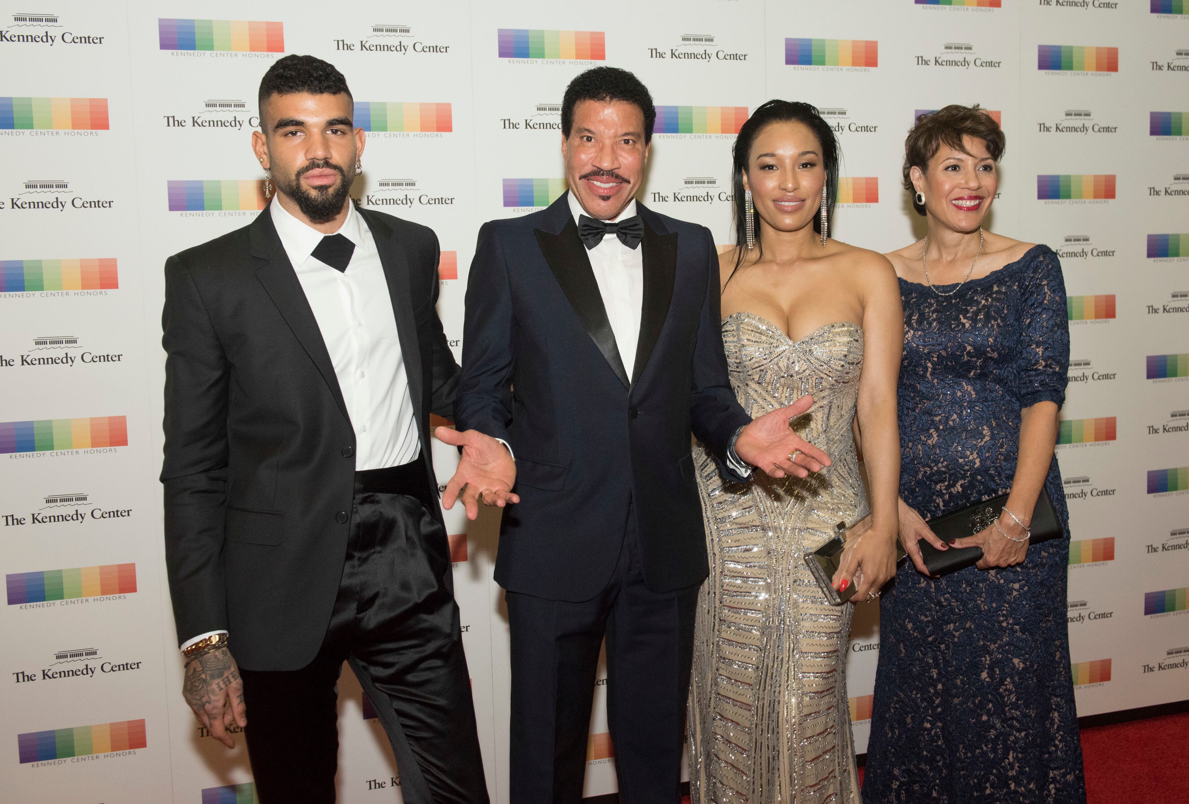 Kennedy Center Honoree Lionel Richie arrives with is son, Miles Richie, left, girlfriend Lisa Parigi, second from right, sister Deborah Richie, right, at the State Department for the Kennedy Center Honors gala dinner, Saturday, Dec. 2, 2017, in Washington. (AP Photo/Kevin Wolf)