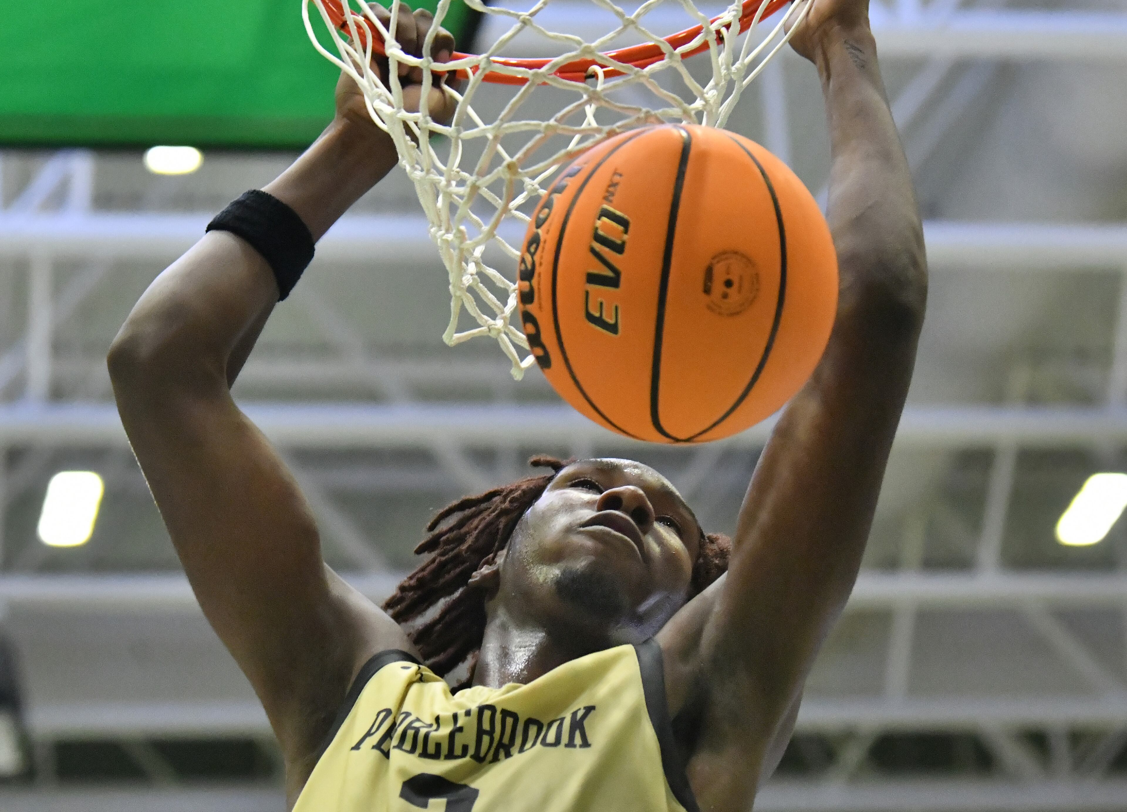 Pebblebrook's Jaiun Simon (3) hangs on the basket after dunking the ball in the second half of 2022 GHSA Basketball Playoffs at Buford Arena on Friday, March 4, 2022. Berkmar won 72-58 over Pebblebrook. (Hyosub Shin / Hyosub.Shin@ajc.com)