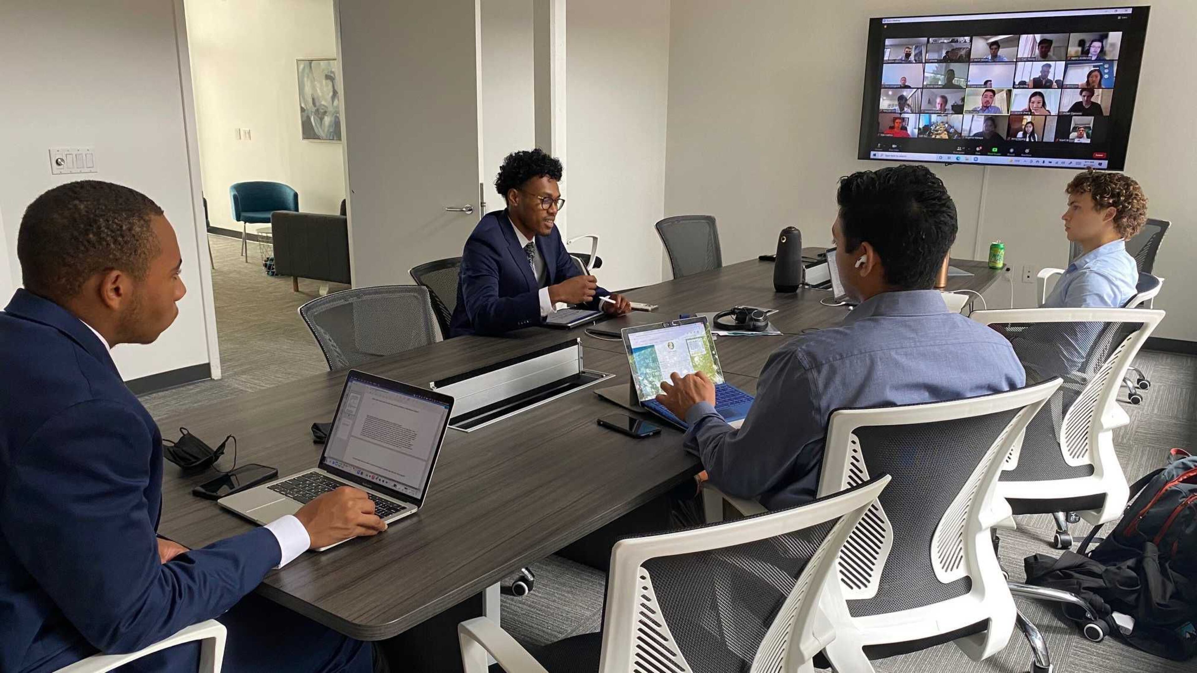 From left to right, Morehouse College students George Lester, Malik Moses, University Growth Fund principal Rakesh Nankani and Georgia Tech student Pearce Seabrook join a group call on Sept. 17, 2021 to discuss potential venture capital deals. The students are in a program that helps review possible fund investments. The fund recently set up an office in downtown Atlanta to recruit more students of color into the program. (ERIC STIRGUS/ERIC.STIRGUS@AJC.COM)