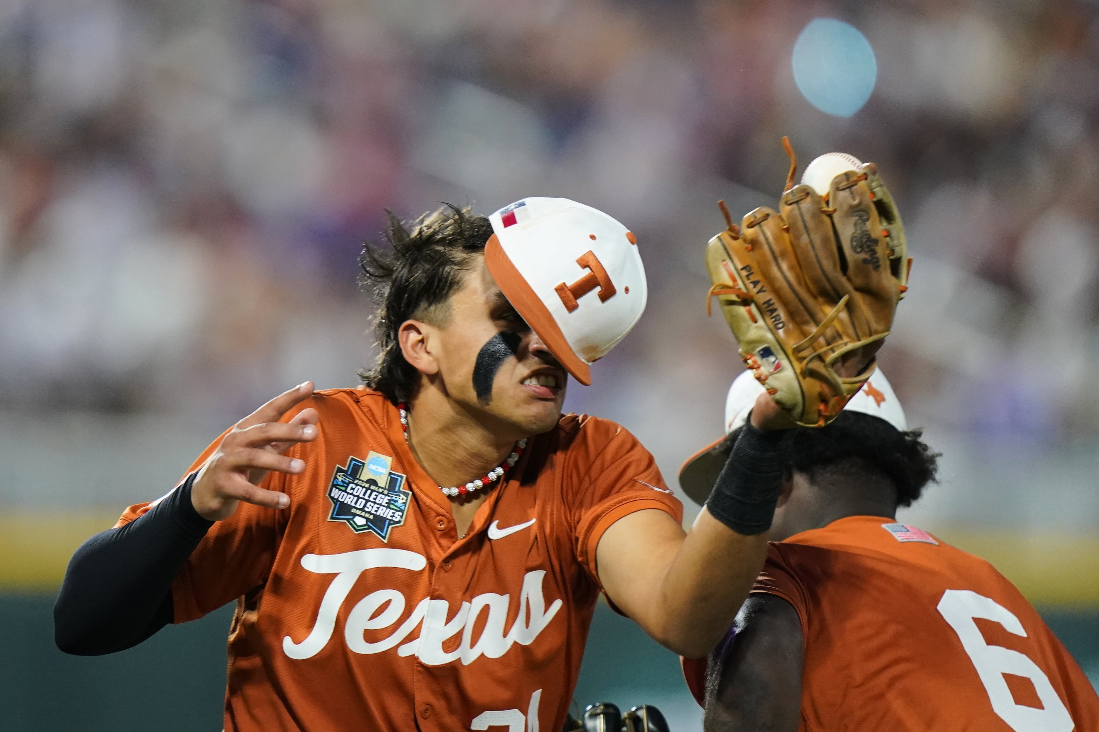 Texas infielder Adrian Rodriguez (24) makes the catch while colliding with outfielder Anthony Pack Jr. (6) during an NCAA baseball College World Series elimination game against Georgia, Tuesday, June 16, 2026 in Omaha, Neb. Georgia won 2-0. (AP Photo/Vera Nieuwenhuis)