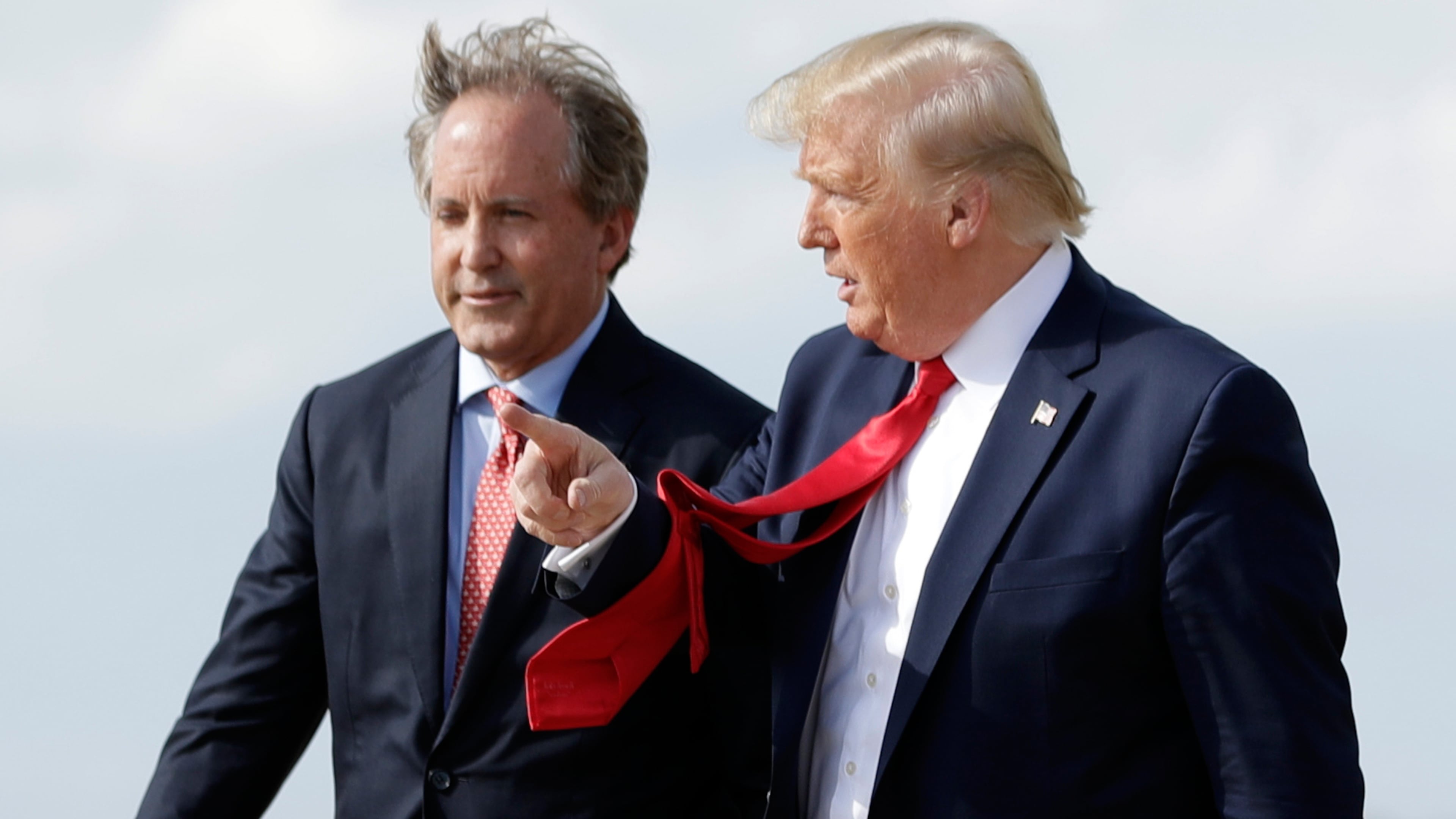FILE - President Donald Trump walks with Texas Attorney General Ken Paxton, left, at Austin-Bergstrom International Airport in Austin, on Wednesday, Nov. 20, 2019. (AP Photo/Evan Vucci, File)