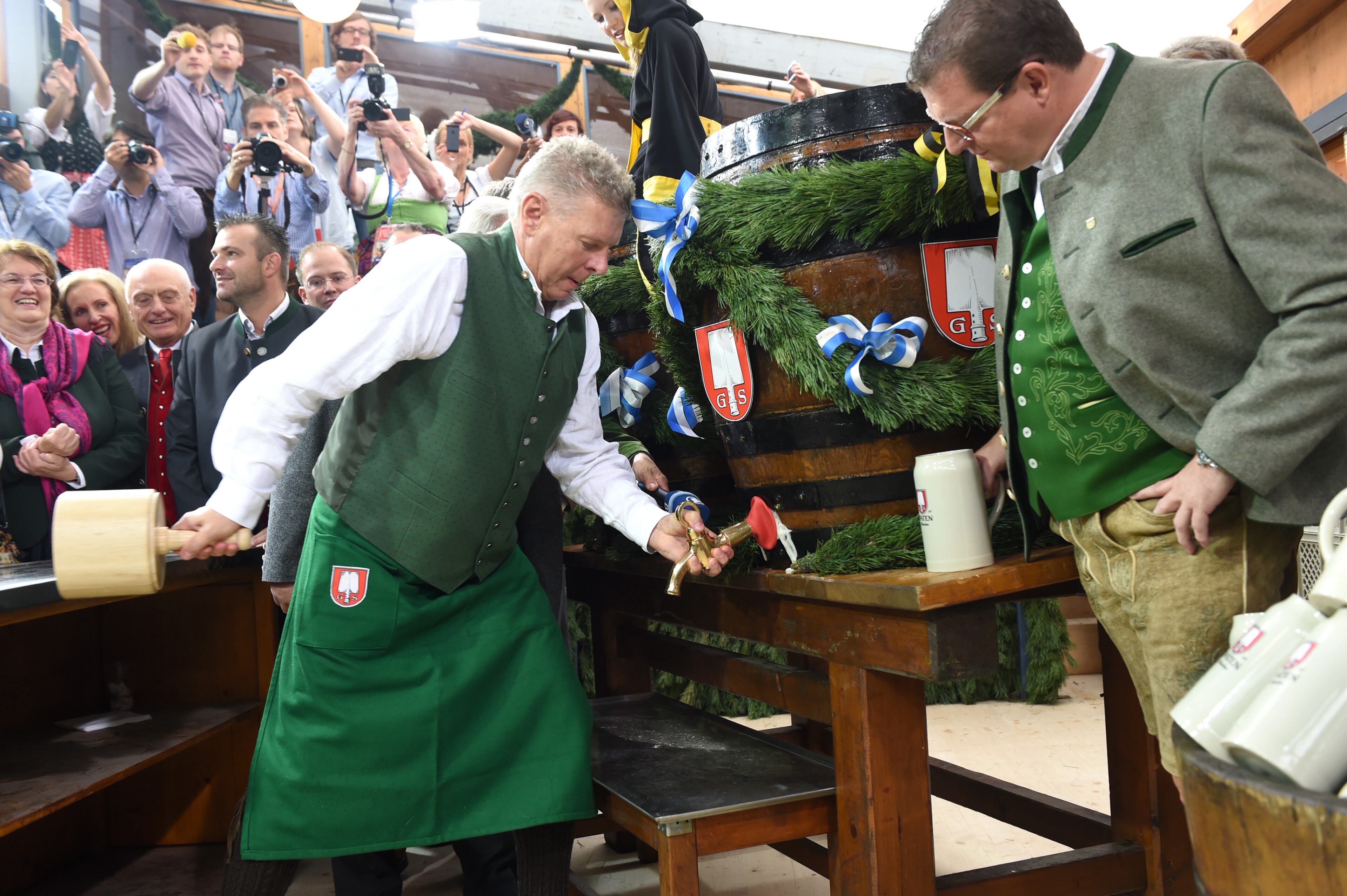 MUNICH, GERMANY - SEPTEMBER 20: Munich new Mayor Dieter Reiter uses a wooden hammer to pound a tap into the first Oktoberfest beer barrel at Schottenhamel beer tent on the opening day of the 2014 Oktoberfest at Theresienwiese on September 20, 2014 in Munich, Germany. (Photo by Hannes Magerstaedt/Getty Images)