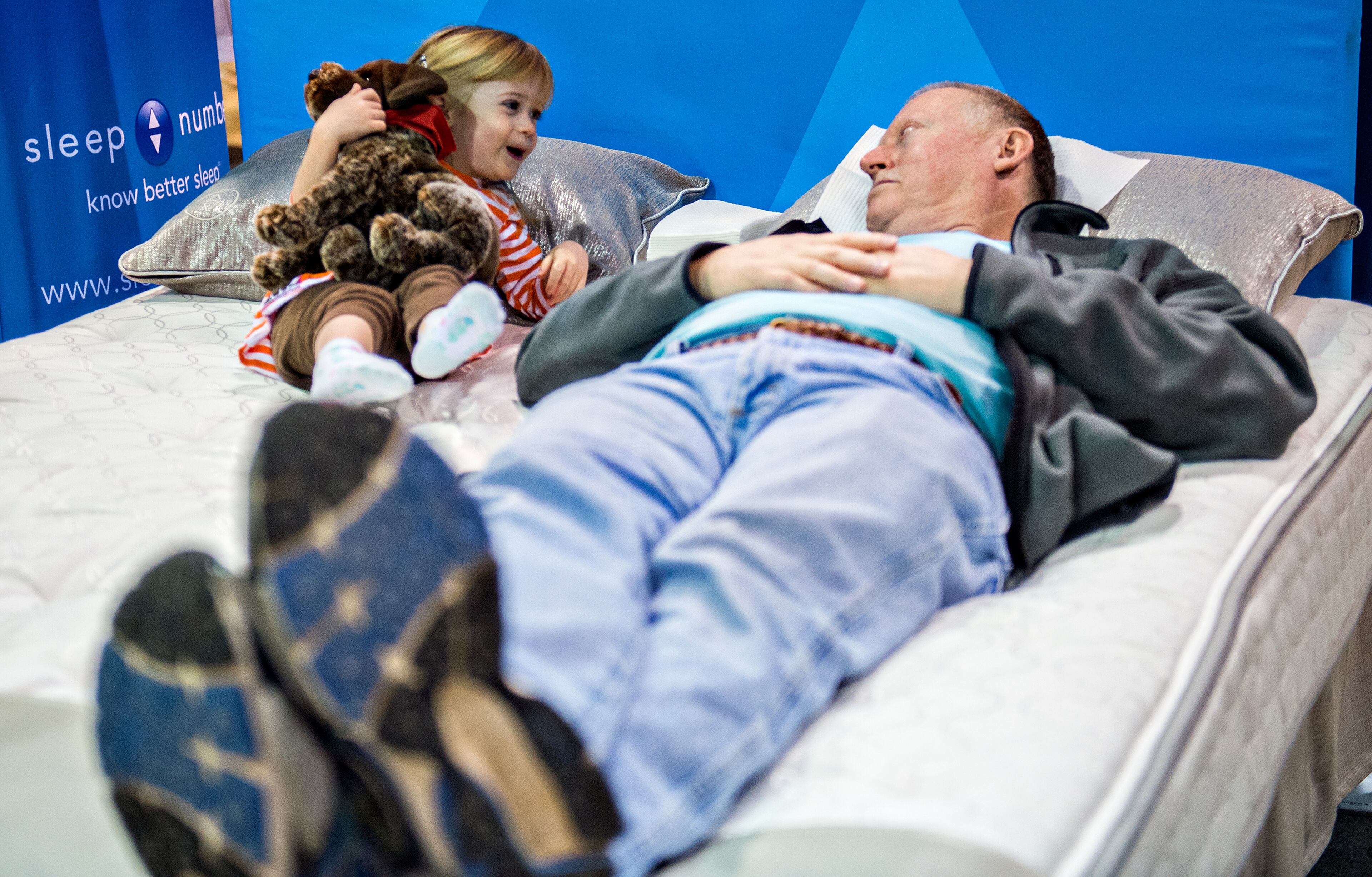 Lora Bucy (left) lays next to her grandfather John as he tries out a sleep number bed during the North Atlanta Home Show at the Infinite Energy Center in Duluth on Saturday, Feb. 20, 2016. JONATHAN PHILLIPS / SPECIAL