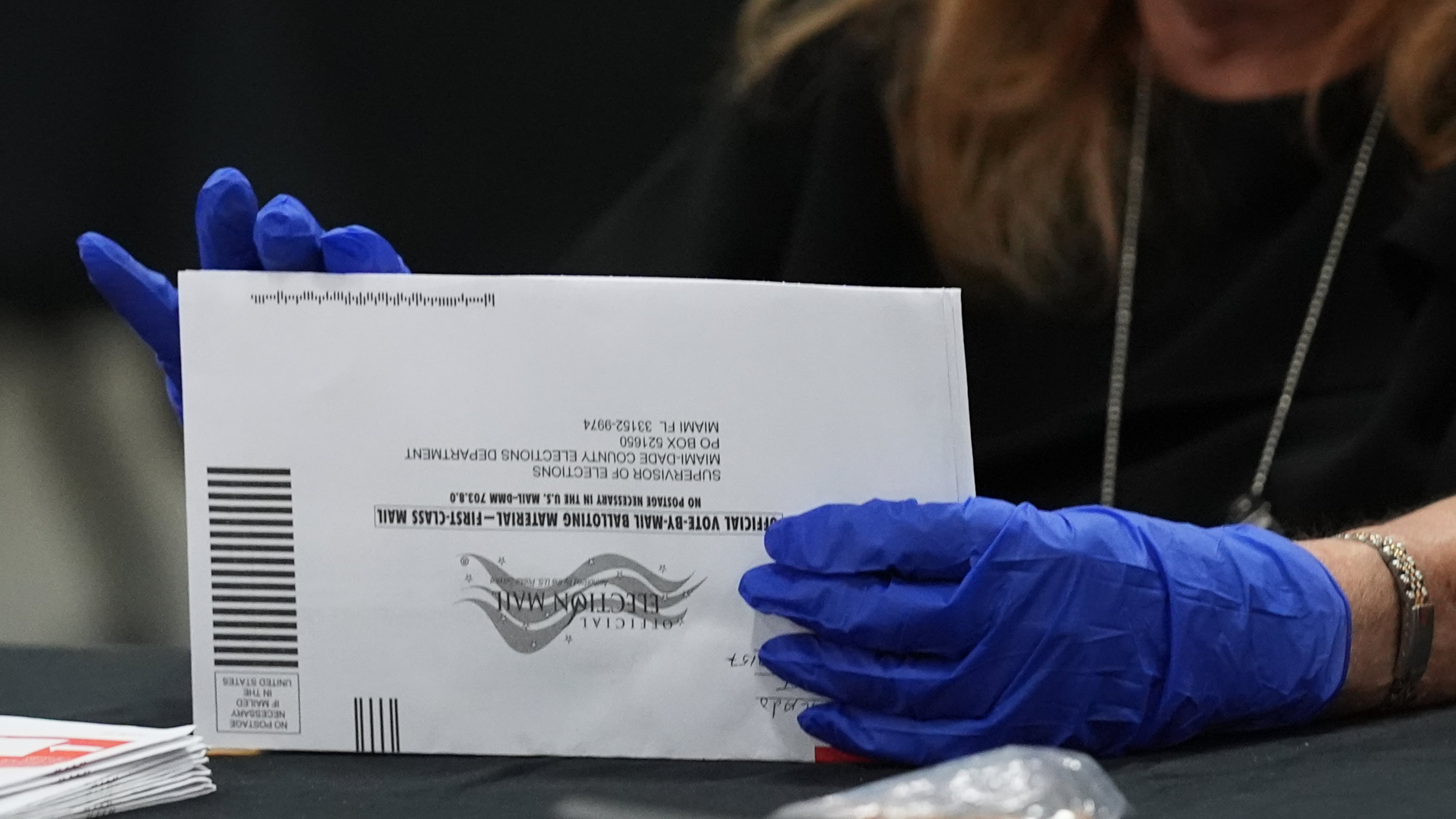 An election worker sorts vote-by-mail ballots at the Miami-Dade County Supervisor of Elections Office for the Florida primary election in Doral, Fla., Tuesday, Aug. 18, 2026. (AP Photo/Lynne Sladky)