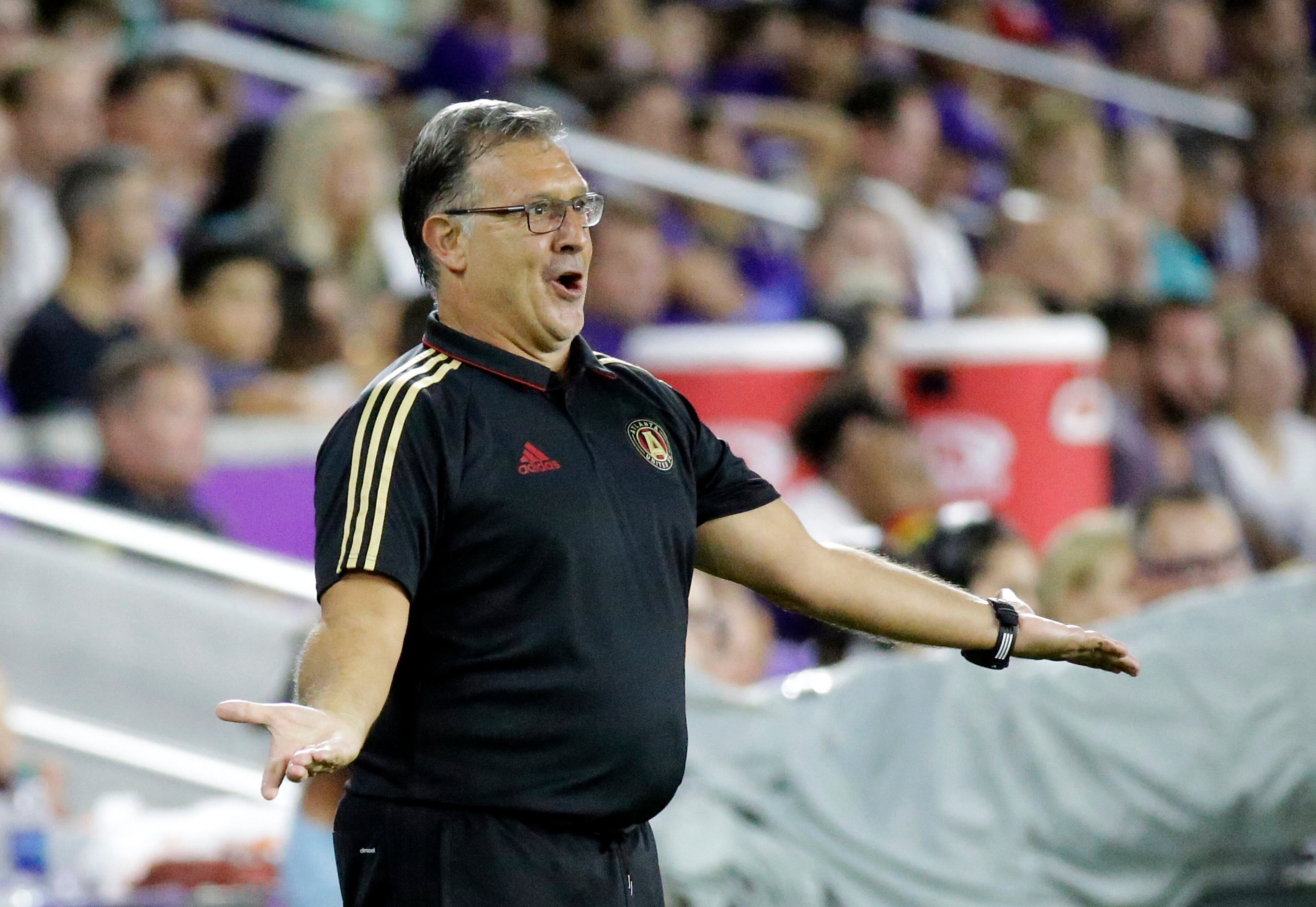 Atlanta United head coach Gerardo Martino makes a plea to his players during the second half of an MLS soccer match against Orlando City, Friday, July 21, 2017, in Orlando, Fla. Atlanta United won 1-0. (AP Photo/John Raoux)